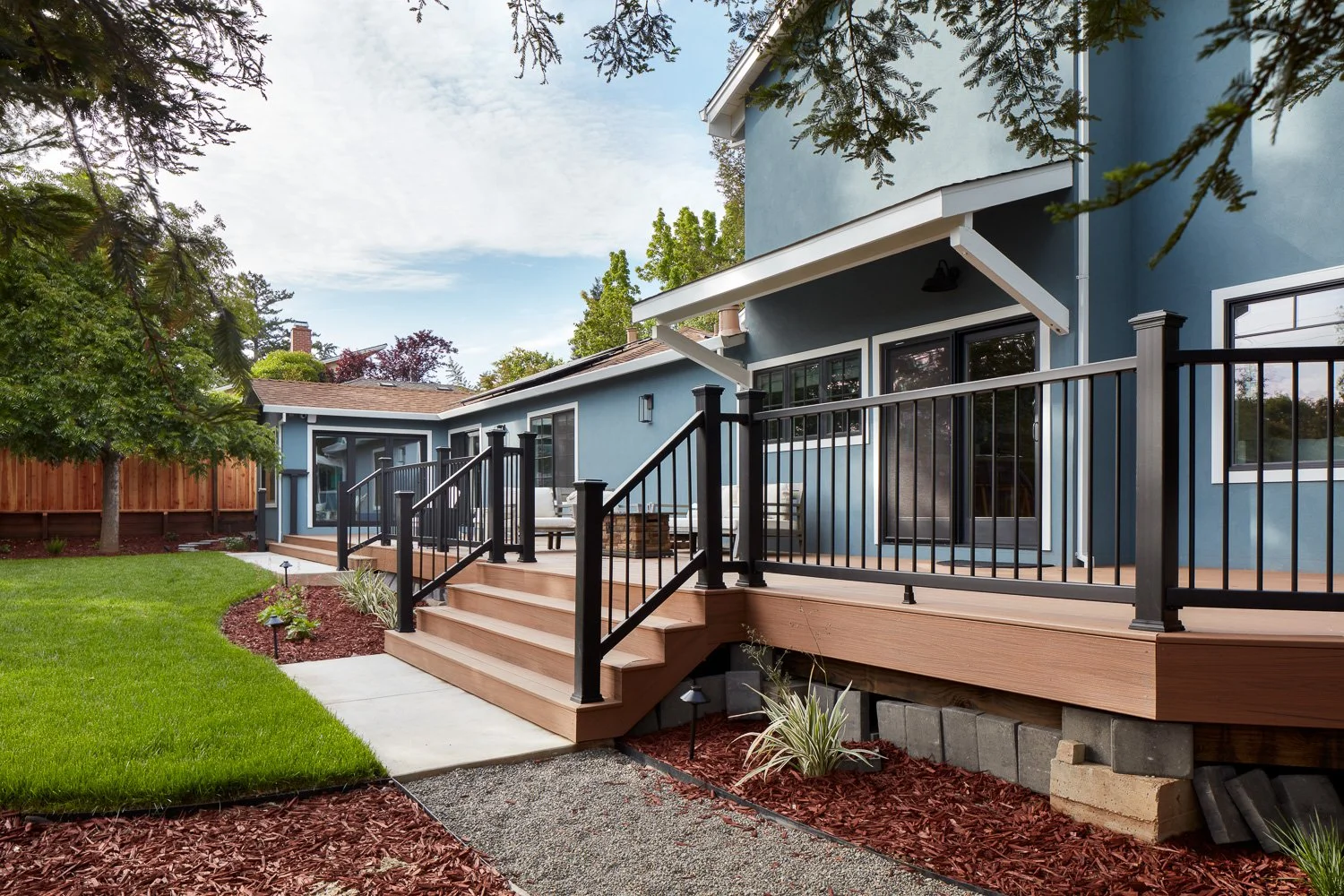 Custom backyard deck with modern railings and seamless indoor-outdoor flow – custom home remodel.