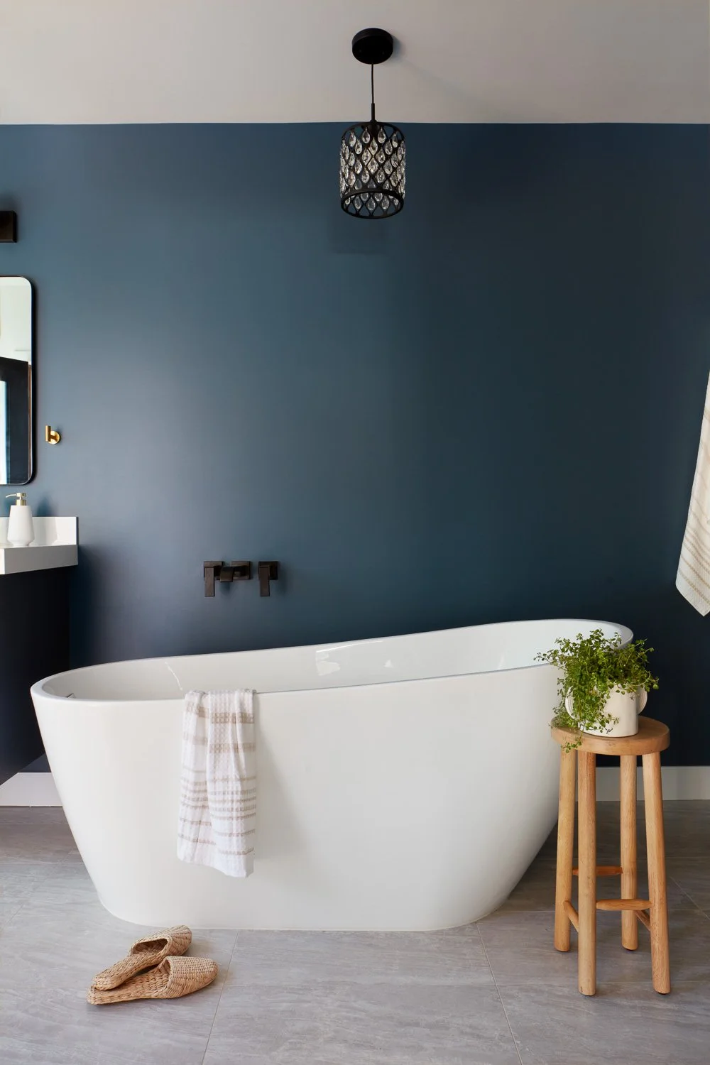 A spa-inspired freestanding tub anchors this serene primary bath in a thoughtfully designed new construction home.