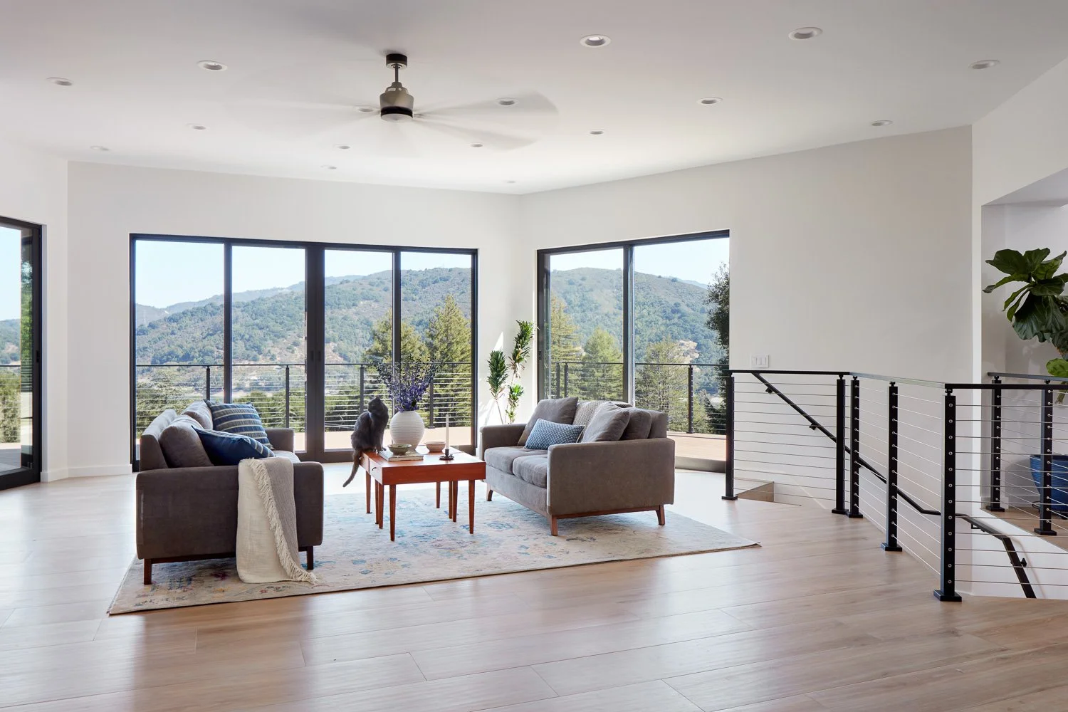 Open living space framed by expansive windows, designed to capture hillside views and flood the home with natural light.