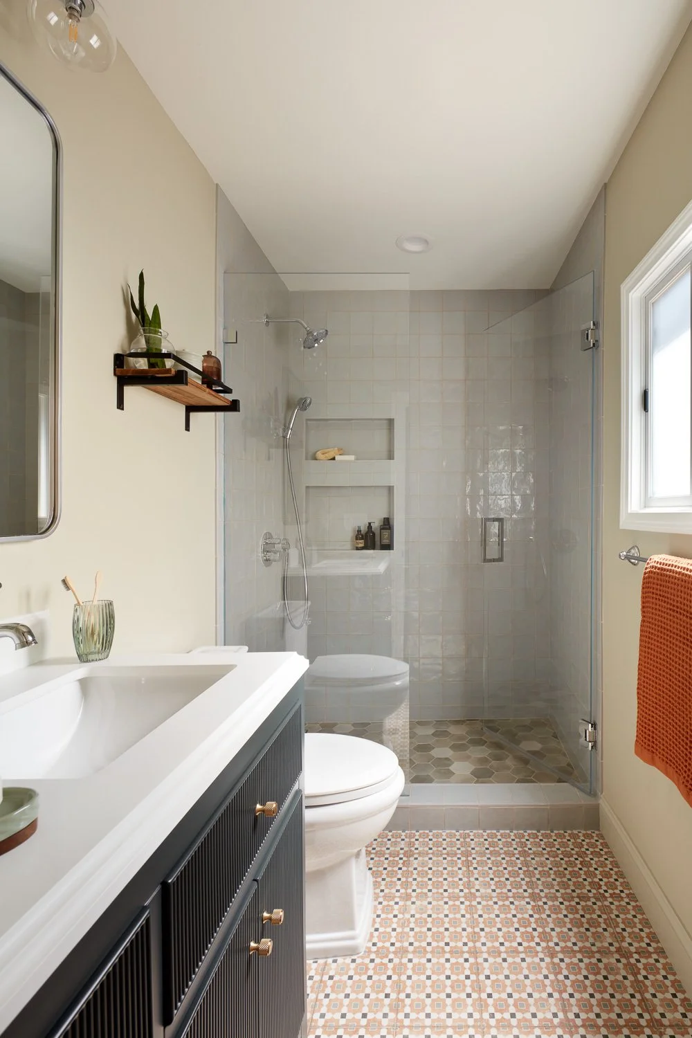 Bright bathroom with soft tones and clean tilework – custom home remodel.