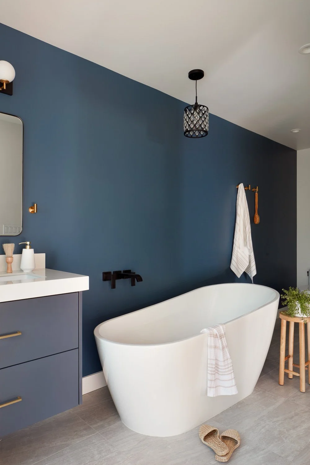 Clean lines and calming finishes define this luxury primary bathroom designed for a custom new construction residence.