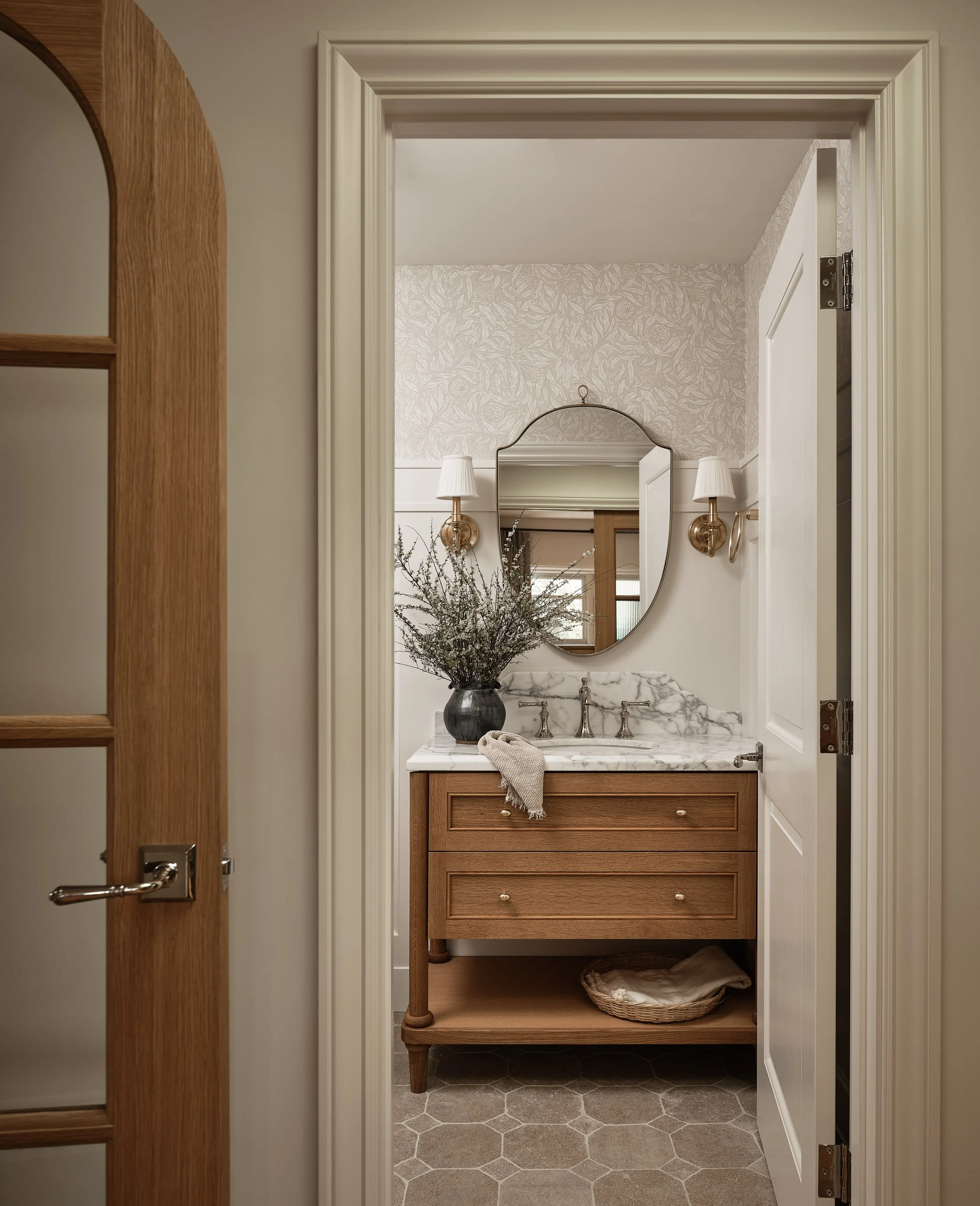 Elegant powder room with marble vanity and warm wood tones in this Addition & Full Home Remodel.