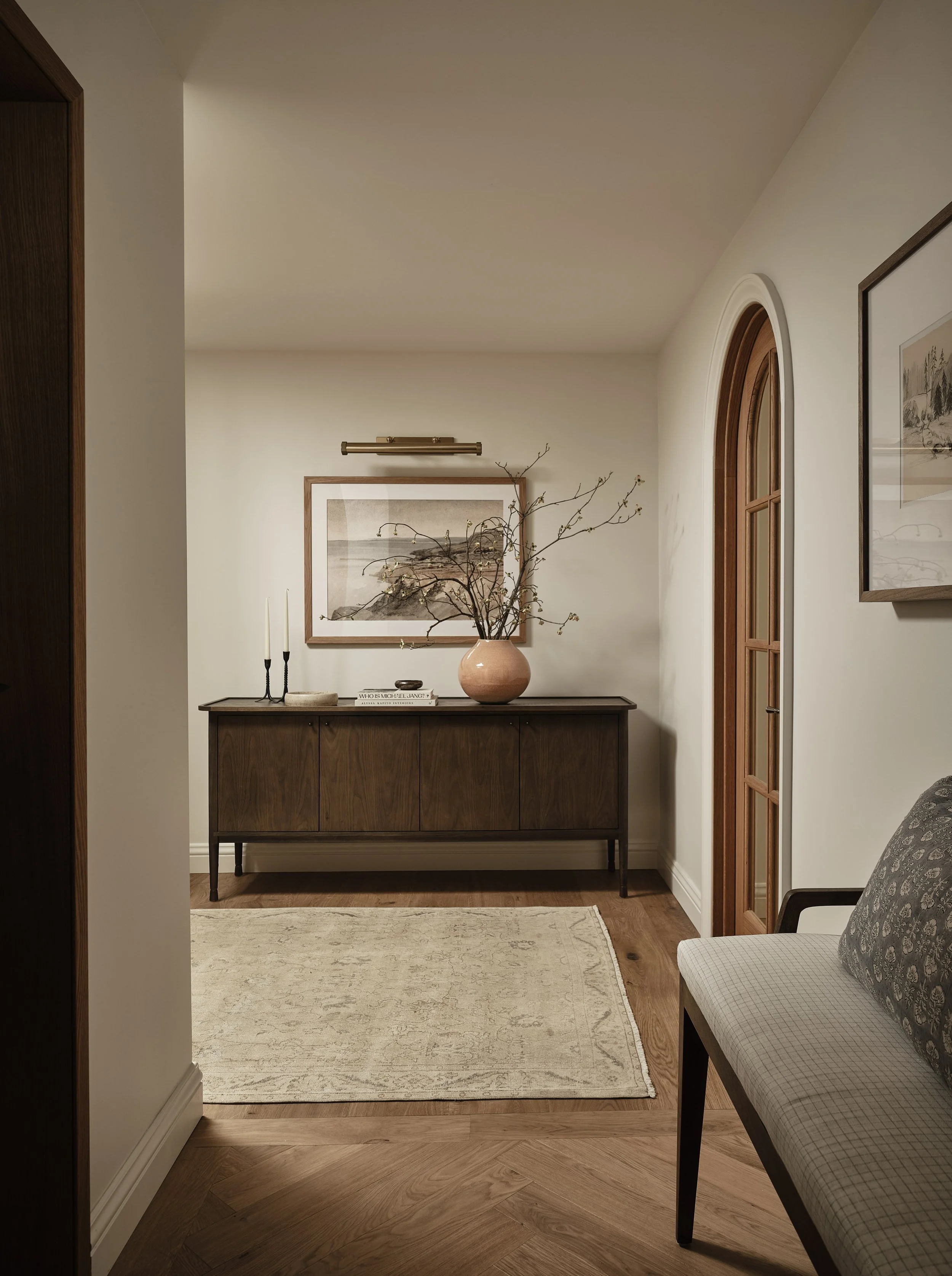 Warm wood flooring and curated finishes create a seamless entry in this Addition & Full Home Remodel.
