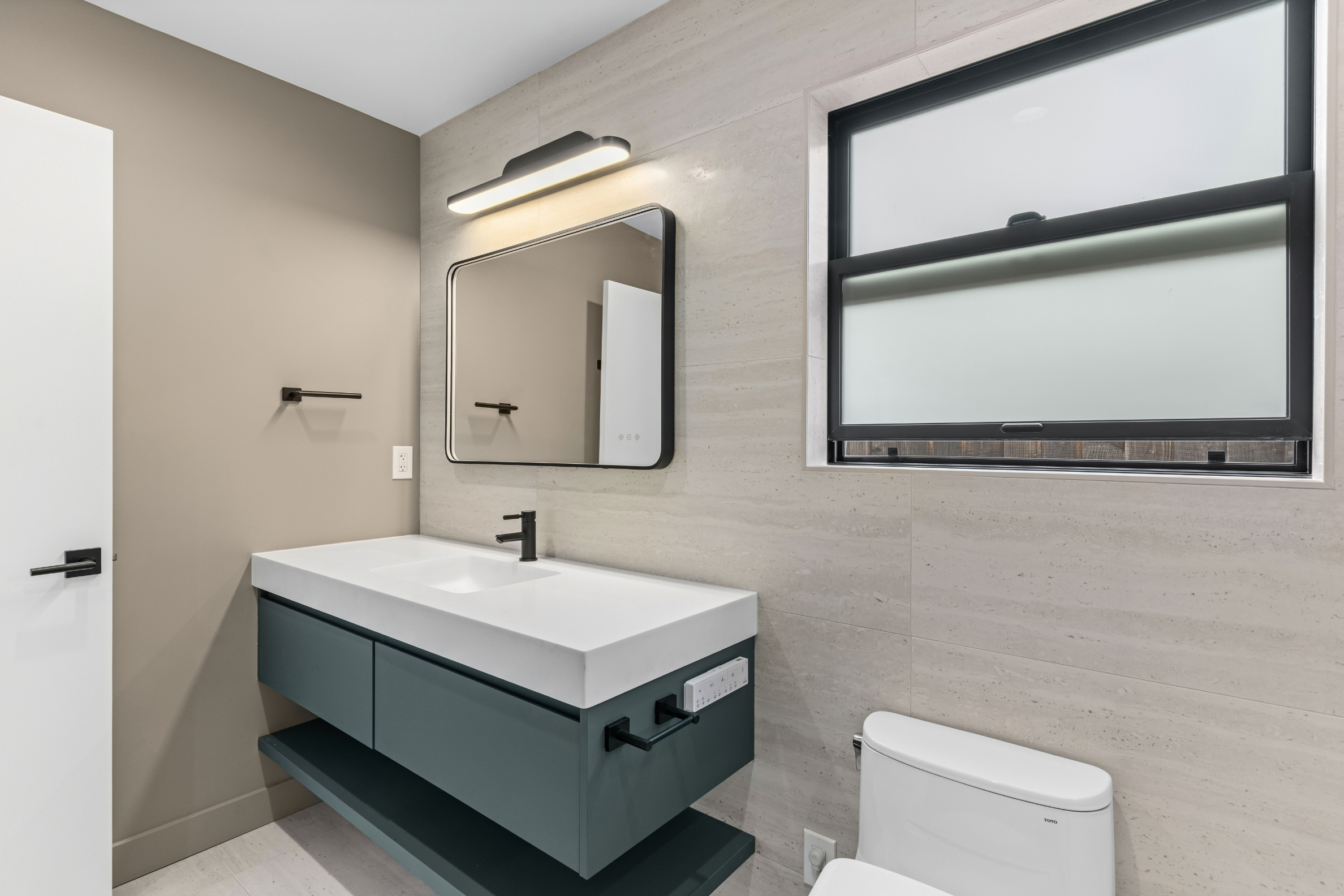 Custom ADU bathroom in San Jose with a floating vanity, modern lighting, and sleek designer finishes.