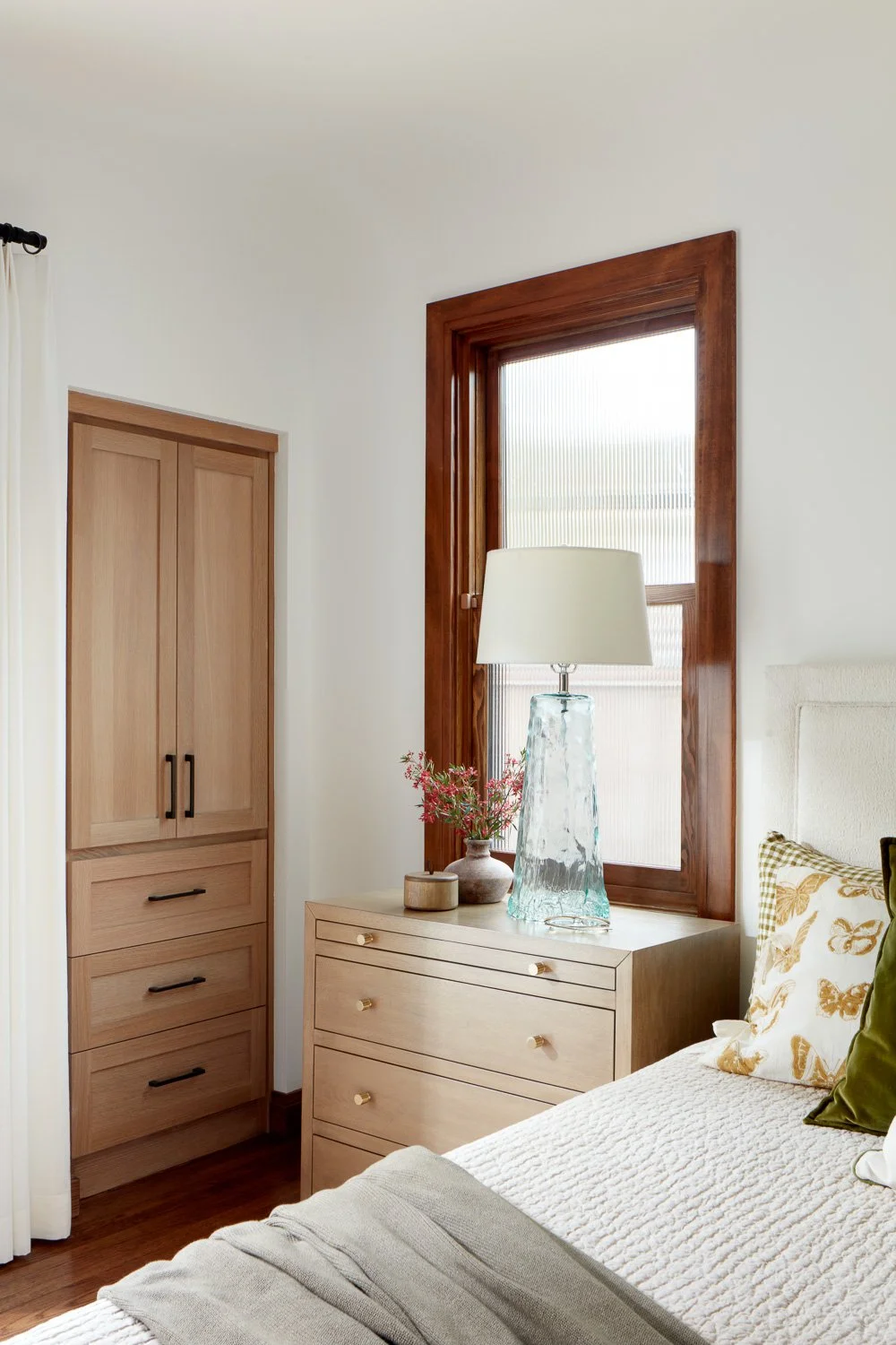 Custom millwork and warm finishes elevate this serene bedroom in our San Mateo full home remodel.