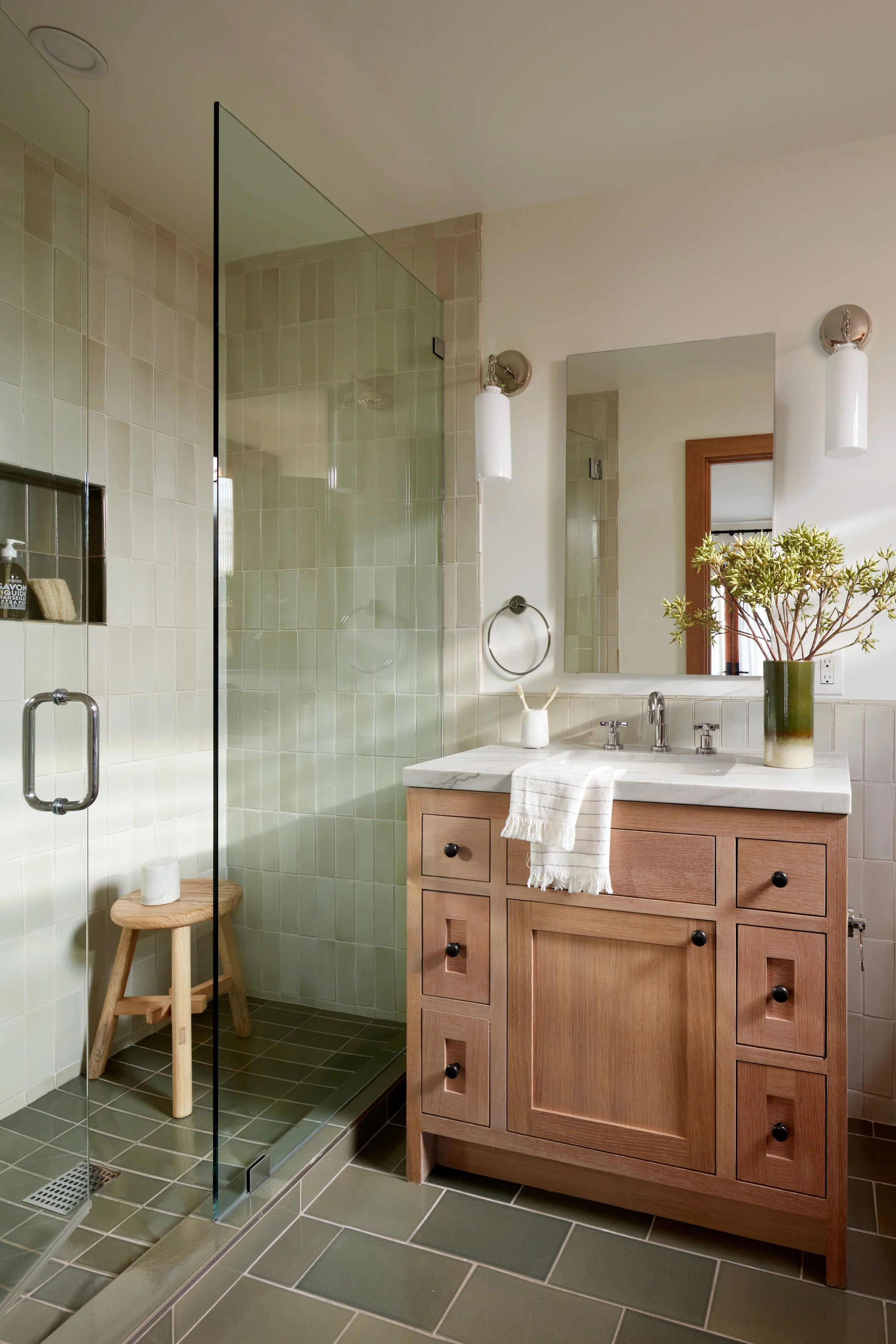 Spa-inspired bathroom remodel with custom wood vanity, glass shower, and soft natural light—designed for comfort and everyday luxury.