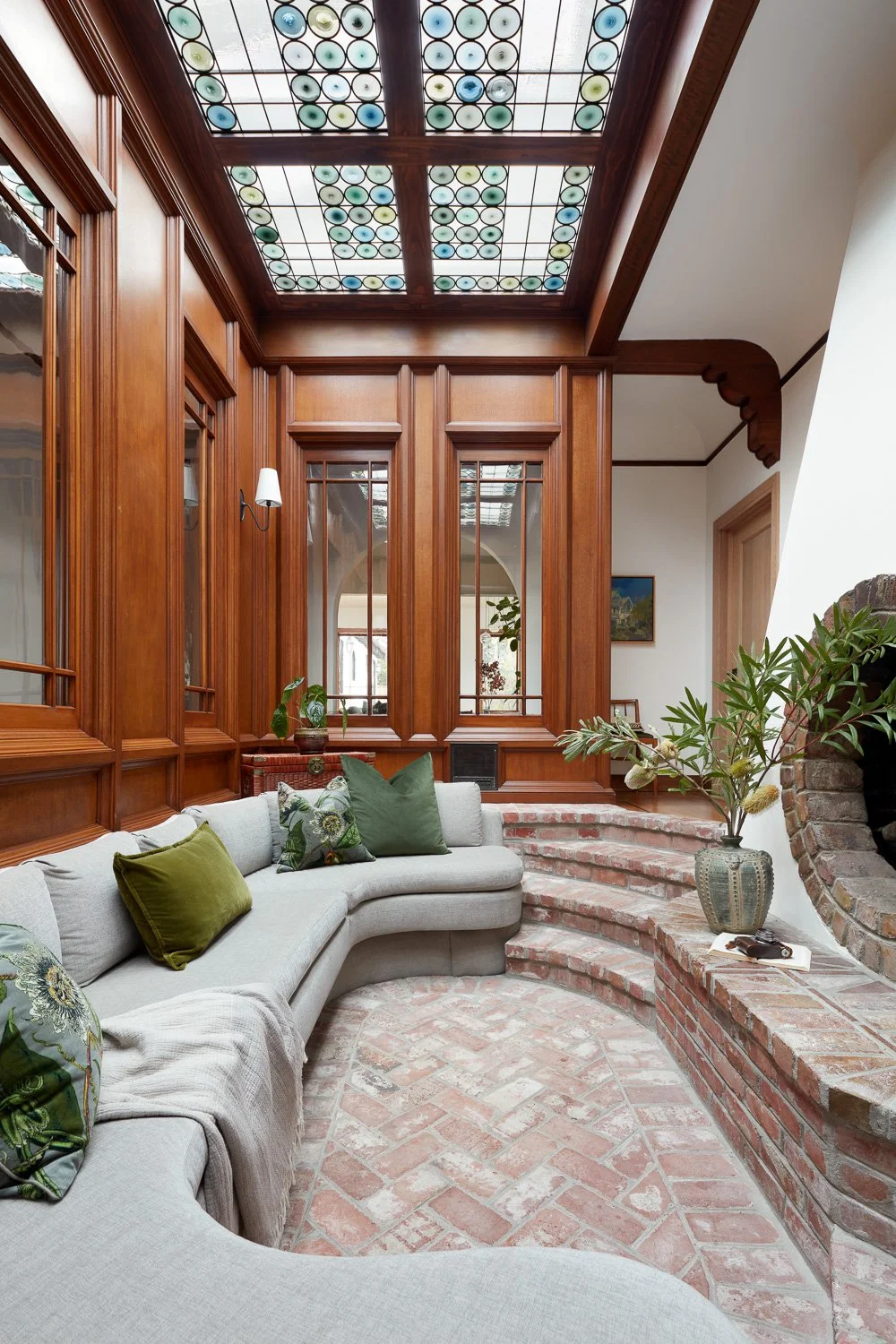Classic craftsmanship meets natural light in this elegant atrium, designed to feel warm, architectural, and inviting.