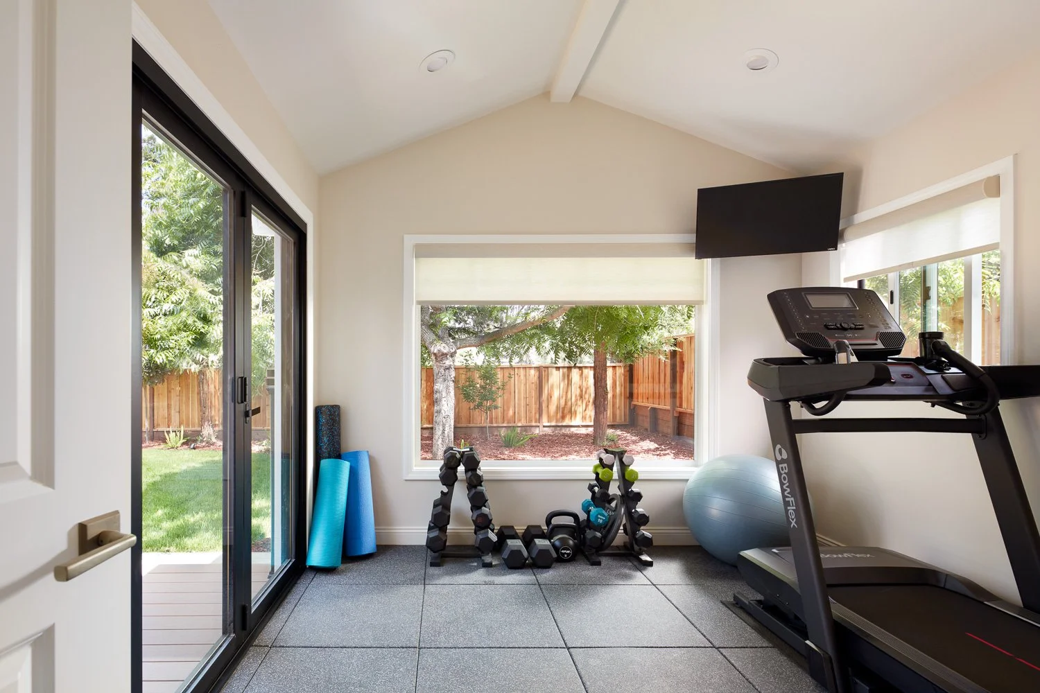 Home gym addition with natural light and backyard views – custom home remodel.