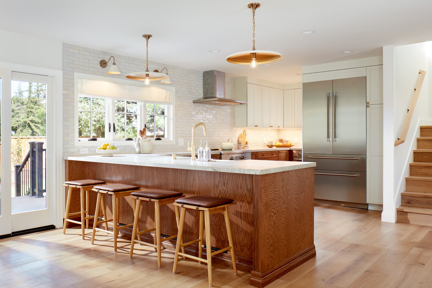 Open kitchen with island seating and clean cabinetry – custom home remodel.