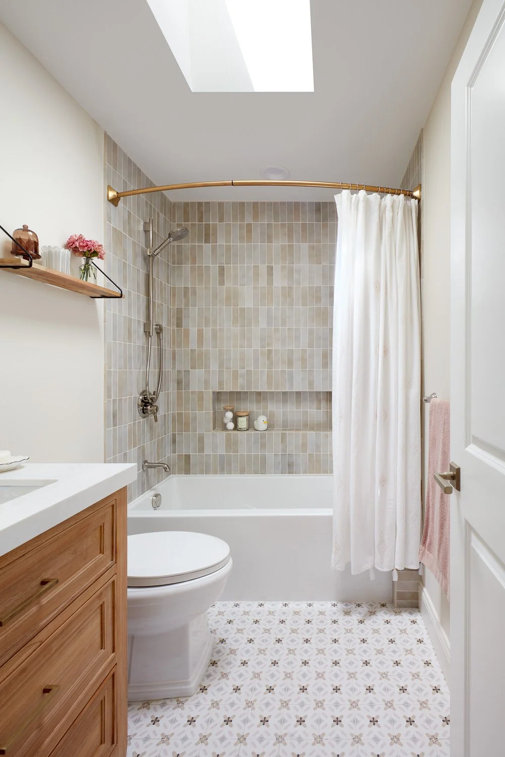 Bright bath with skylight and timeless finishes – custom home remodel.