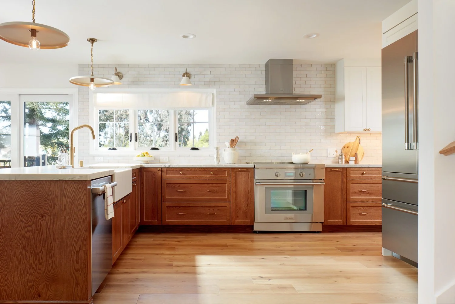 Warm kitchen design with custom cabinetry and tile backsplash – custom home remodel.