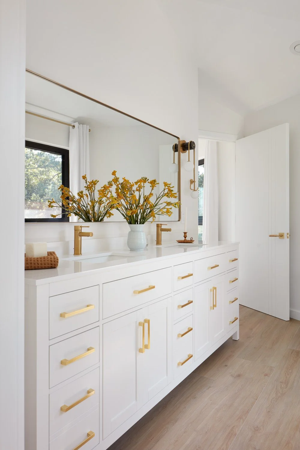 Warm finishes and thoughtful details elevate this bathroom into a relaxing, hotel-style escape.