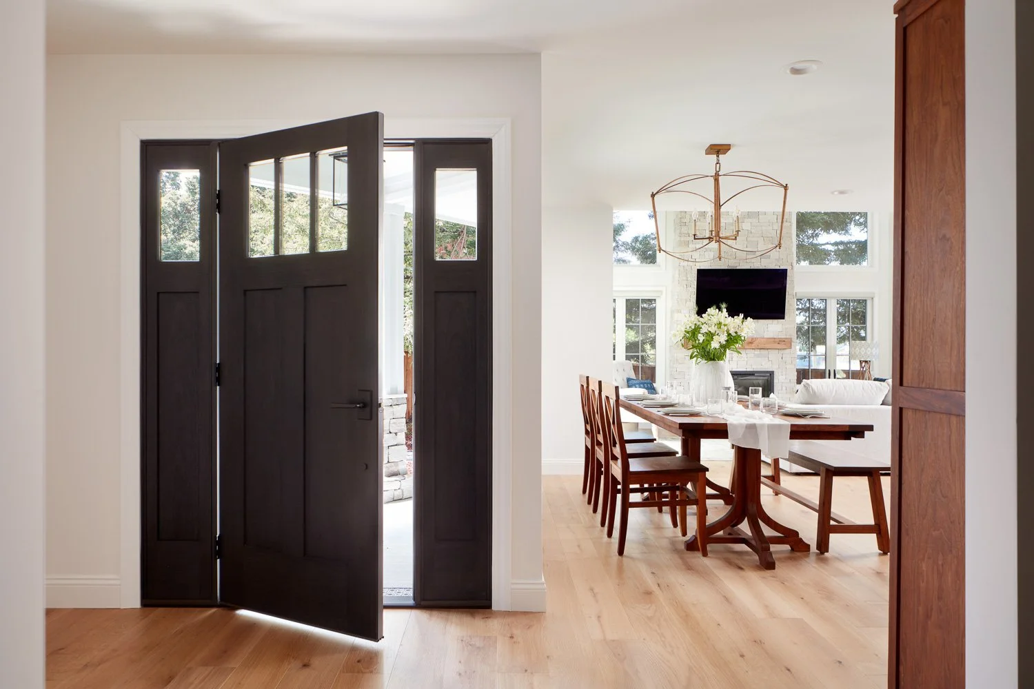 Welcoming entry with wide plank flooring and open sightlines – custom home remodel.