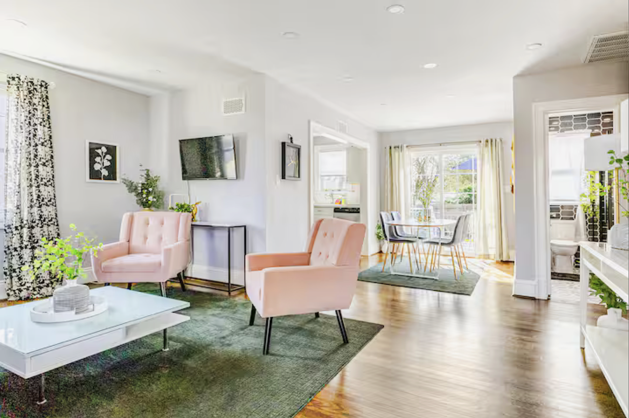 The living room, dining area, deck and kitchen connect in an open floor plan.