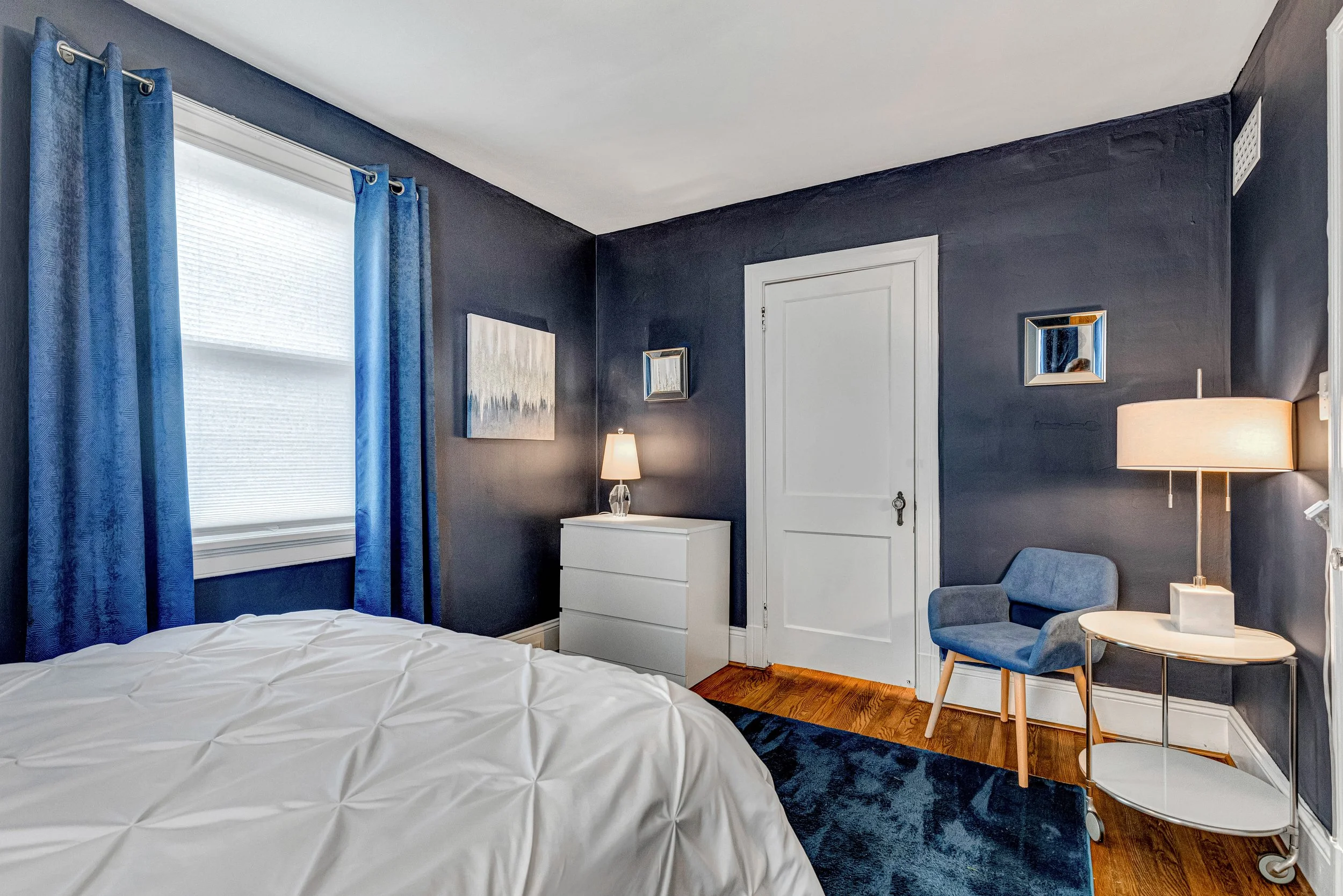 Bedroom mirrors, drawers for clothing and a charming seating area.