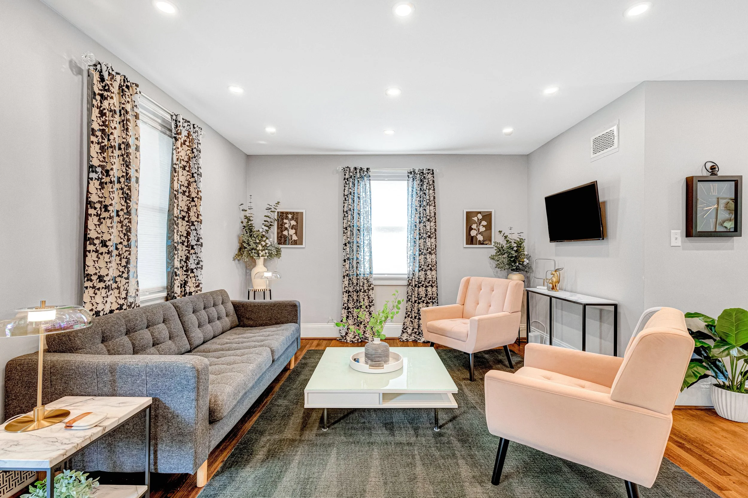Luxury living room with contemporary decor, Smart TV and natural light.