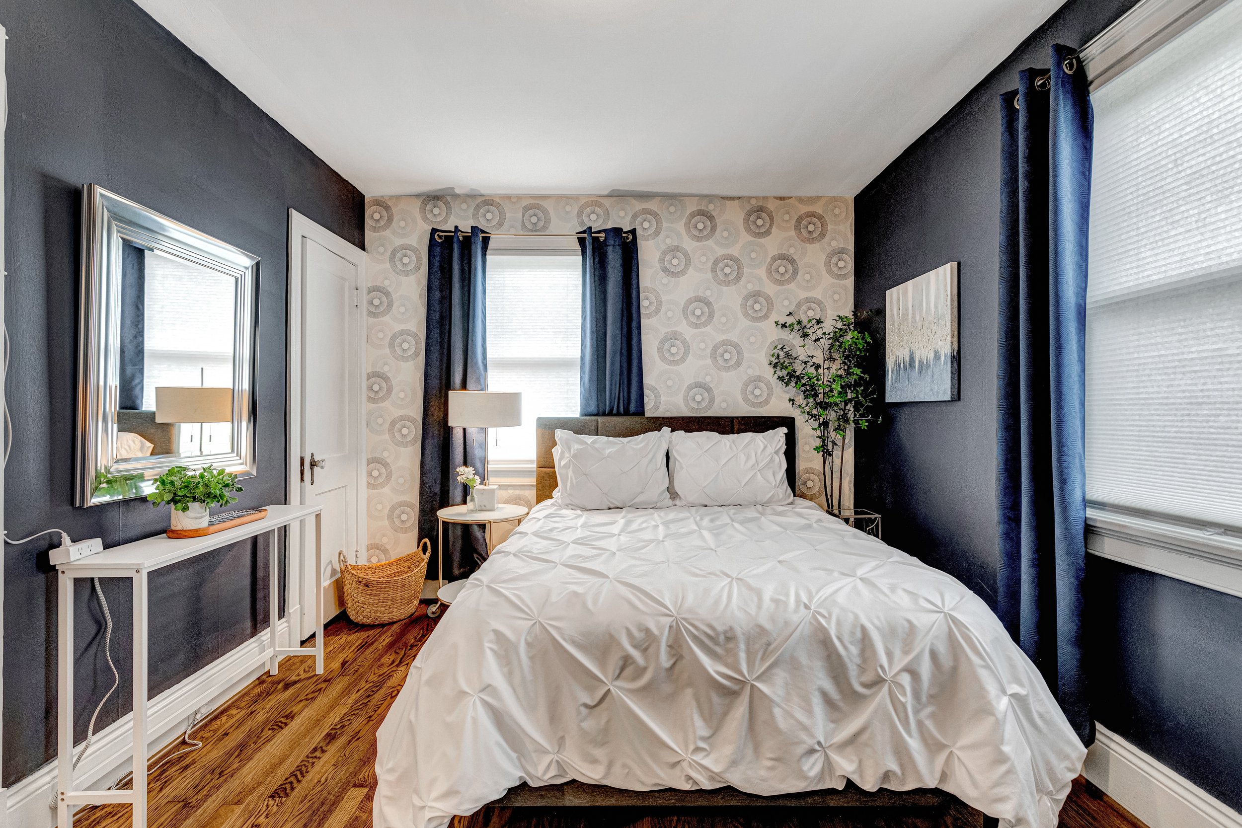 Beautiful art, a closet for clothing storage and comfortable bed.