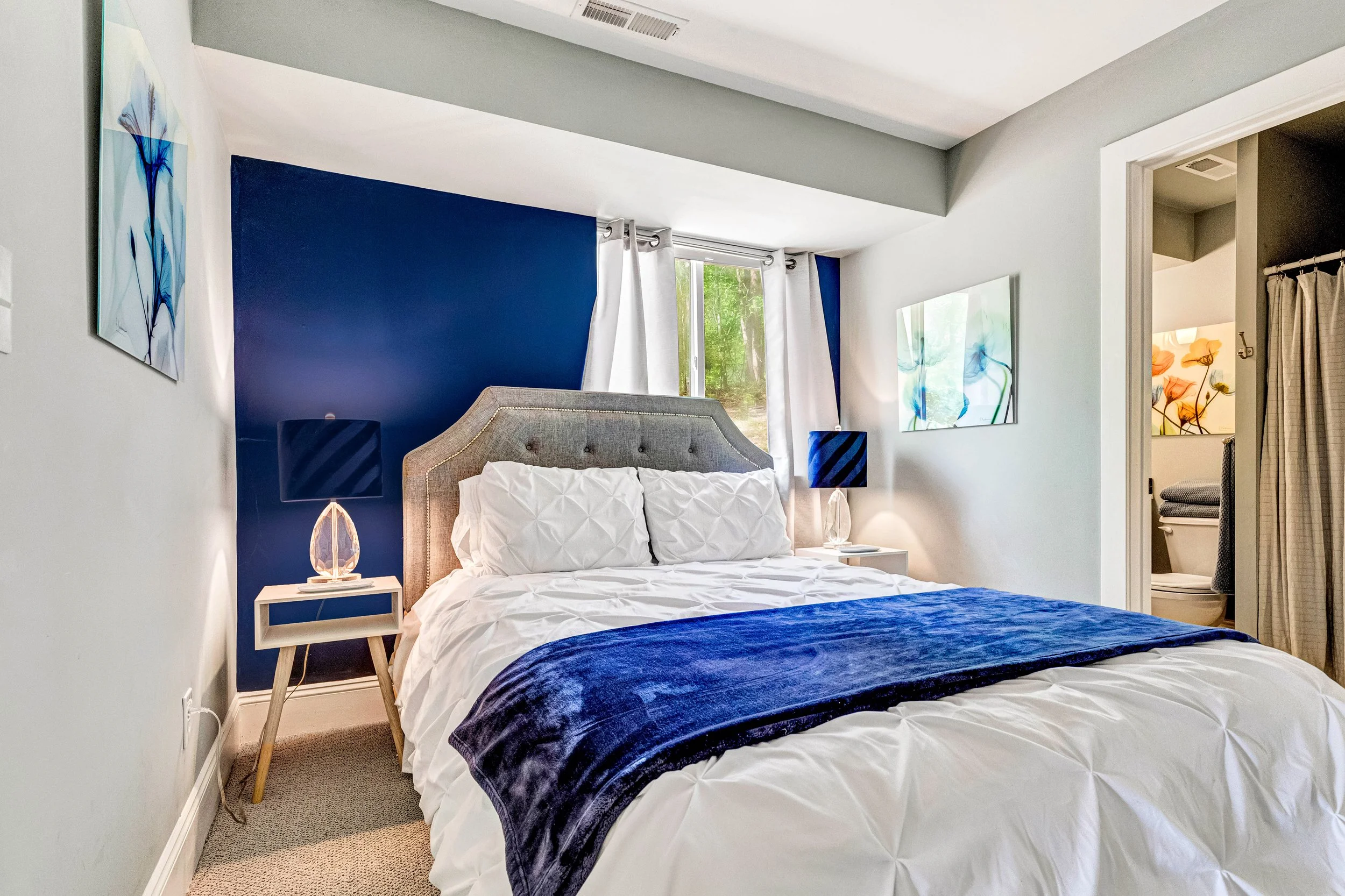 The blue bedroom with a private bathroom and blackout curtains for a peaceful sleep. 