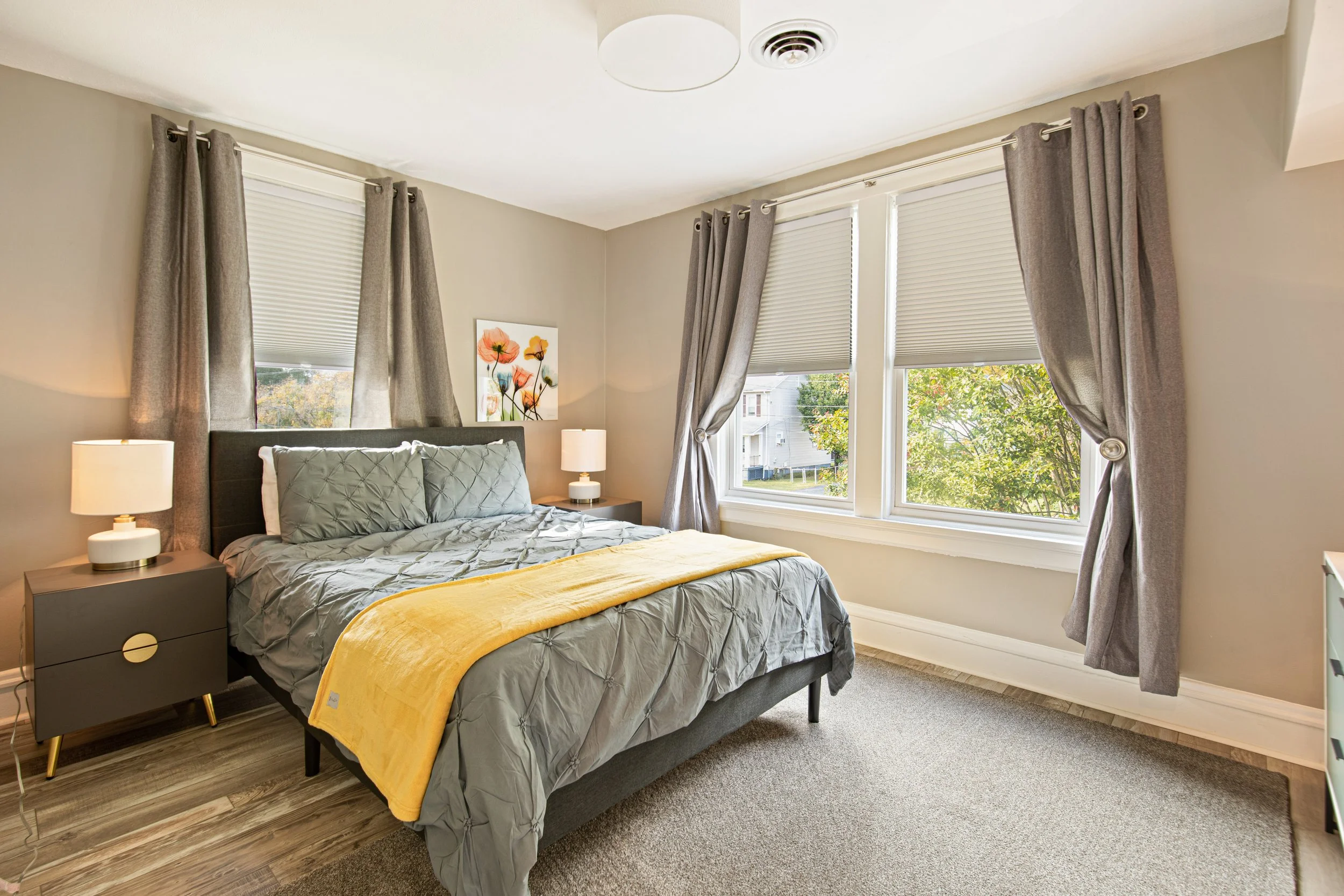 The second bedroom with a comfy queen sized bed and sunny windows.