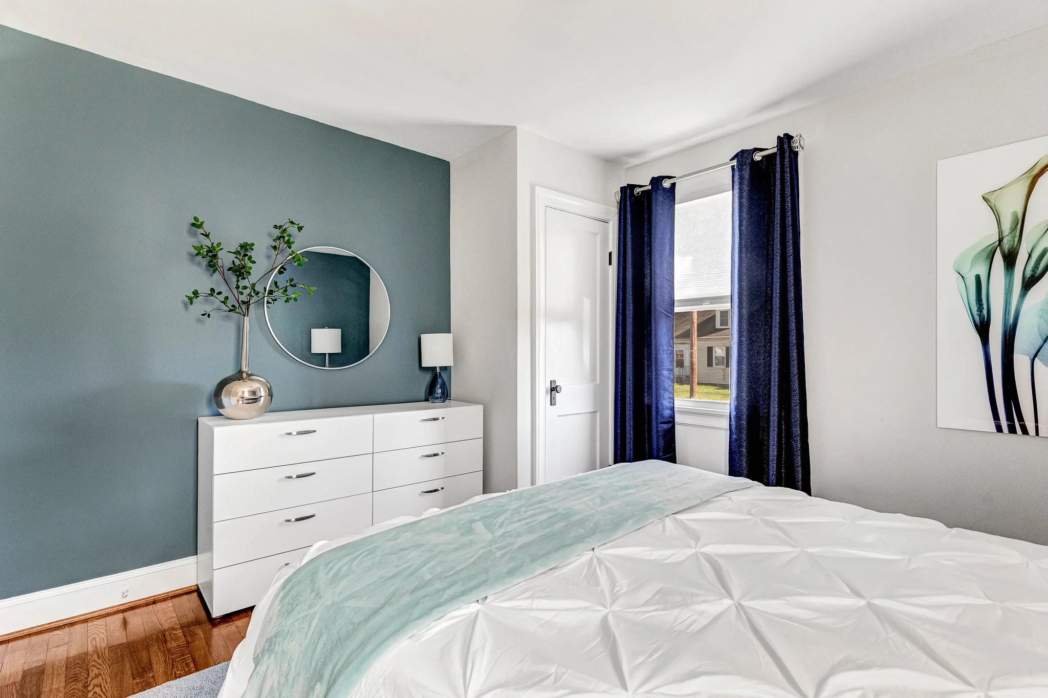 Ample clothing storage with full dresser, closet space, and blackout curtains for a restful night's sleep.