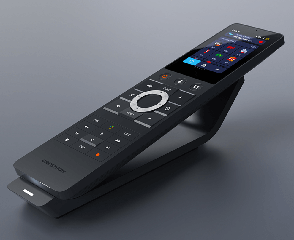 A modern remote control with a touchscreen display and various buttons, placed on a stand.