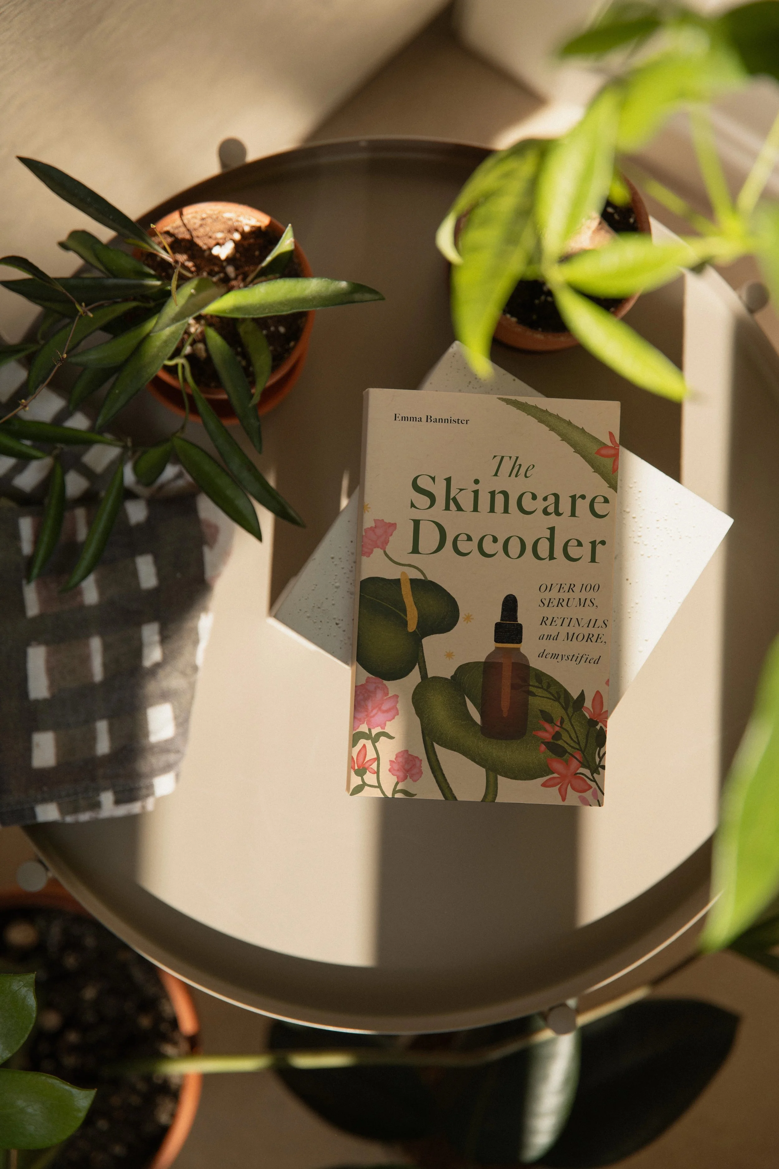 Mockuuups Copy of Paperback mockup on a round table with plants.jpeg