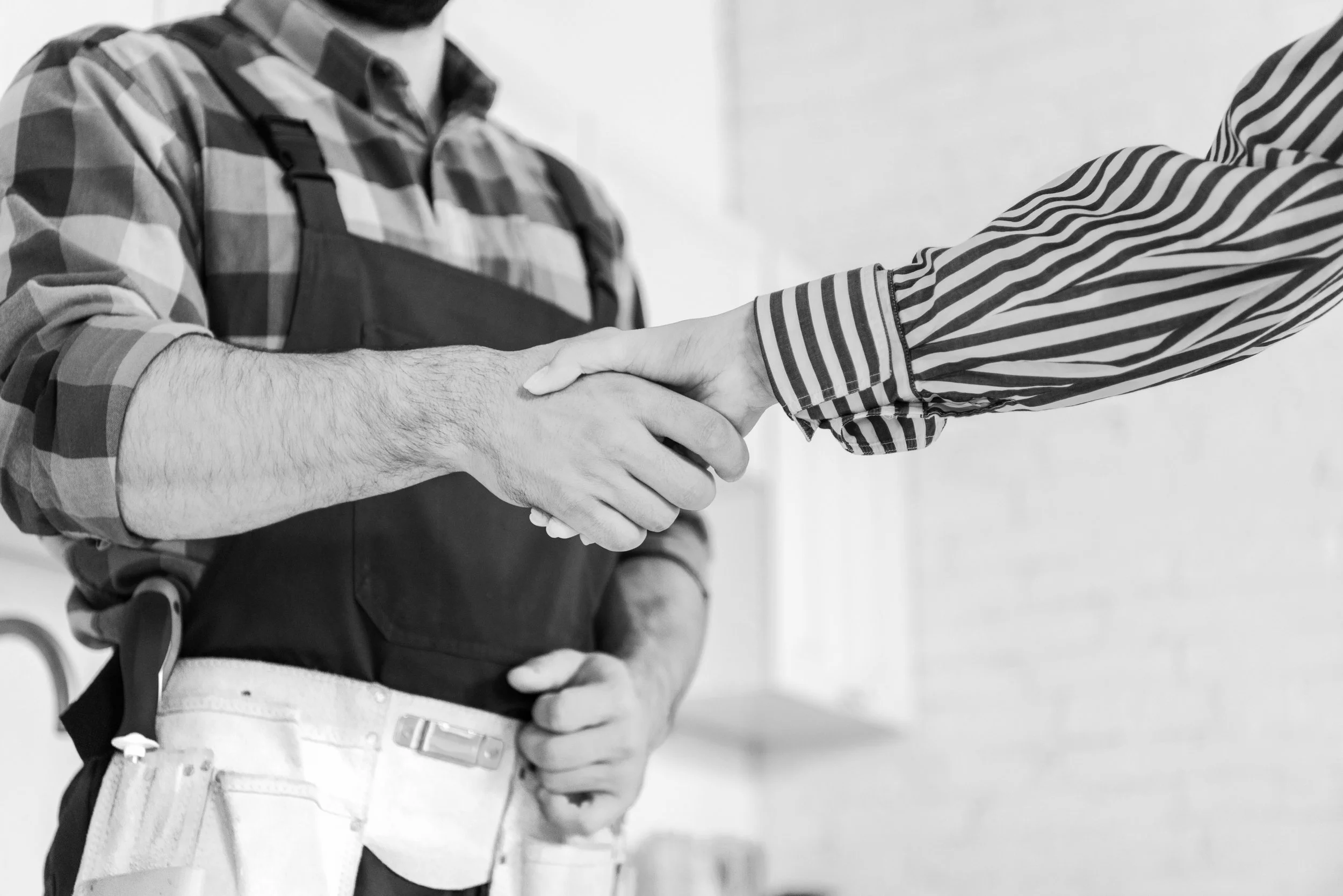 cropped-view-of-woman-shaking-hands-with-handyman-2022-11-03-03-37-21-utc-bw.jpg