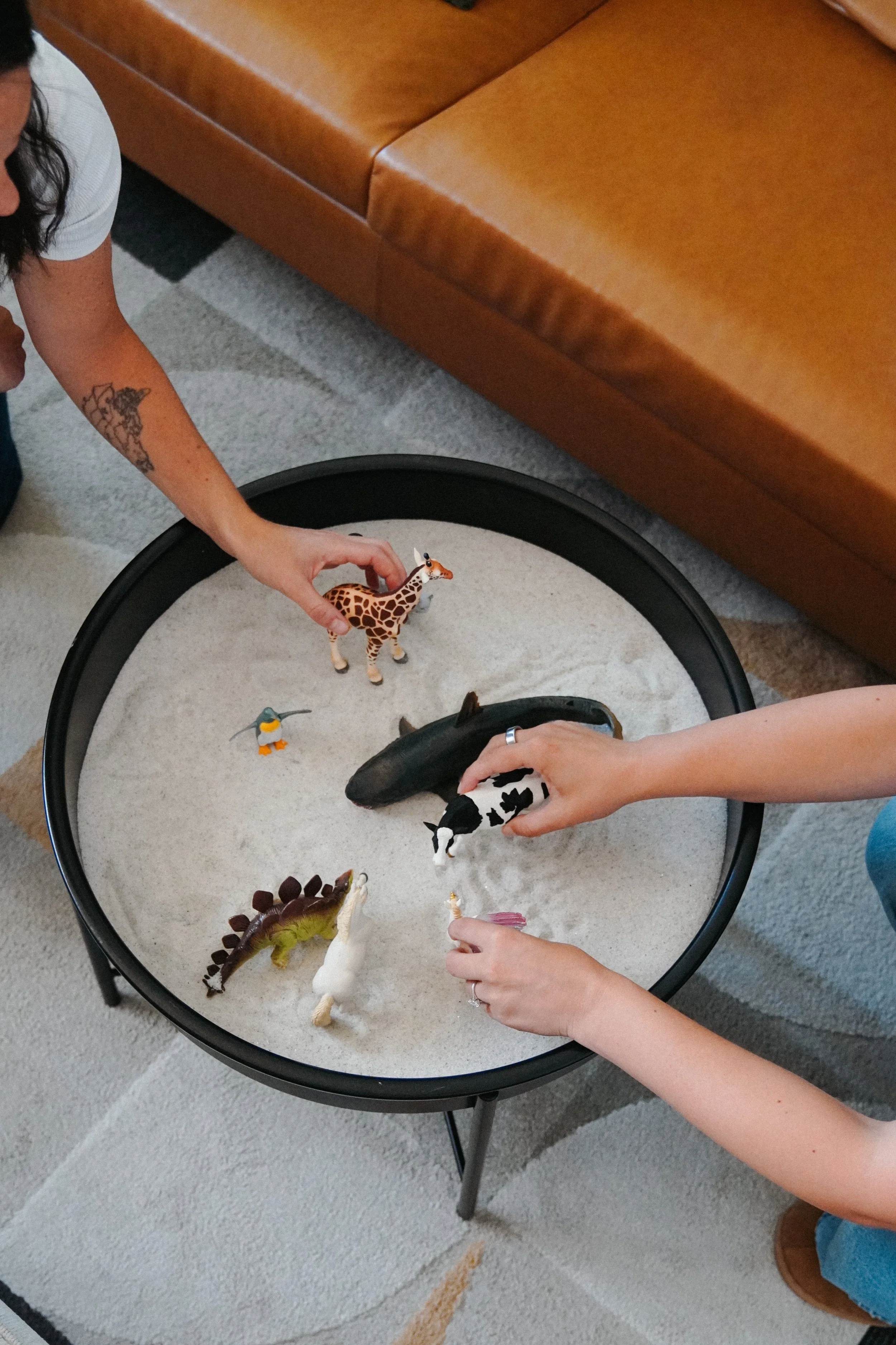 figurines being used in the sand as a form of therapy, frequently used at Youology to support teens and families struggling with trauma, depression, anxiety and family conflict