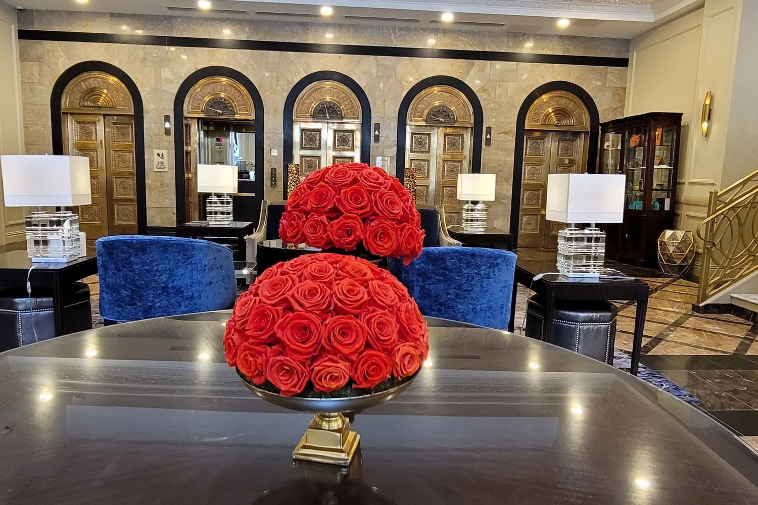 Hotel lobby with red roses and blue velvet chairs