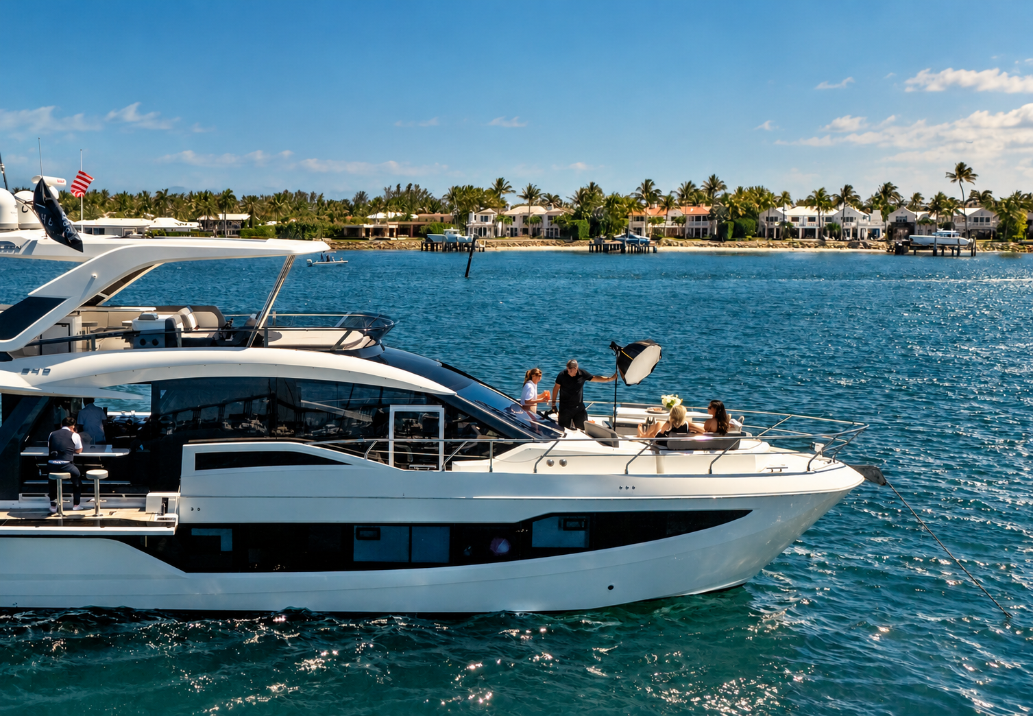 Photography crew working aboard a yacht on blue coastal waters, representing Fuse Mediaworks commercial photography.