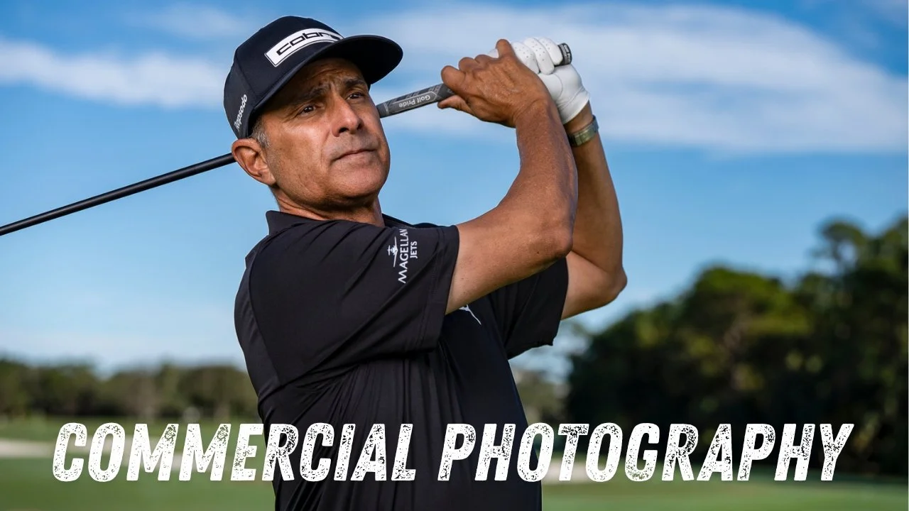 A man playing golf, swinging a golf club outdoors on a sunny day with trees and blue sky in the background, with the text "Commercial Photography" at the bottom.