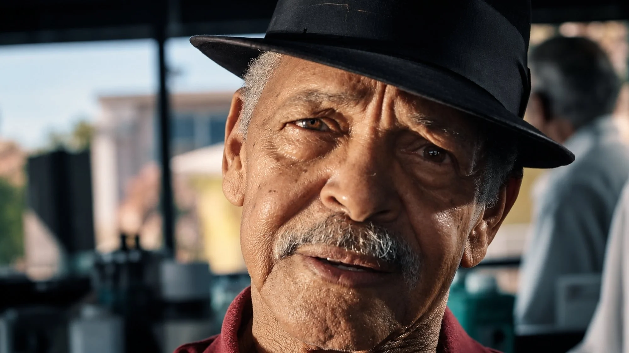 Close portrait of a man wearing a black hat in a narrative film featuring cinematography by Paul Piasecki.
