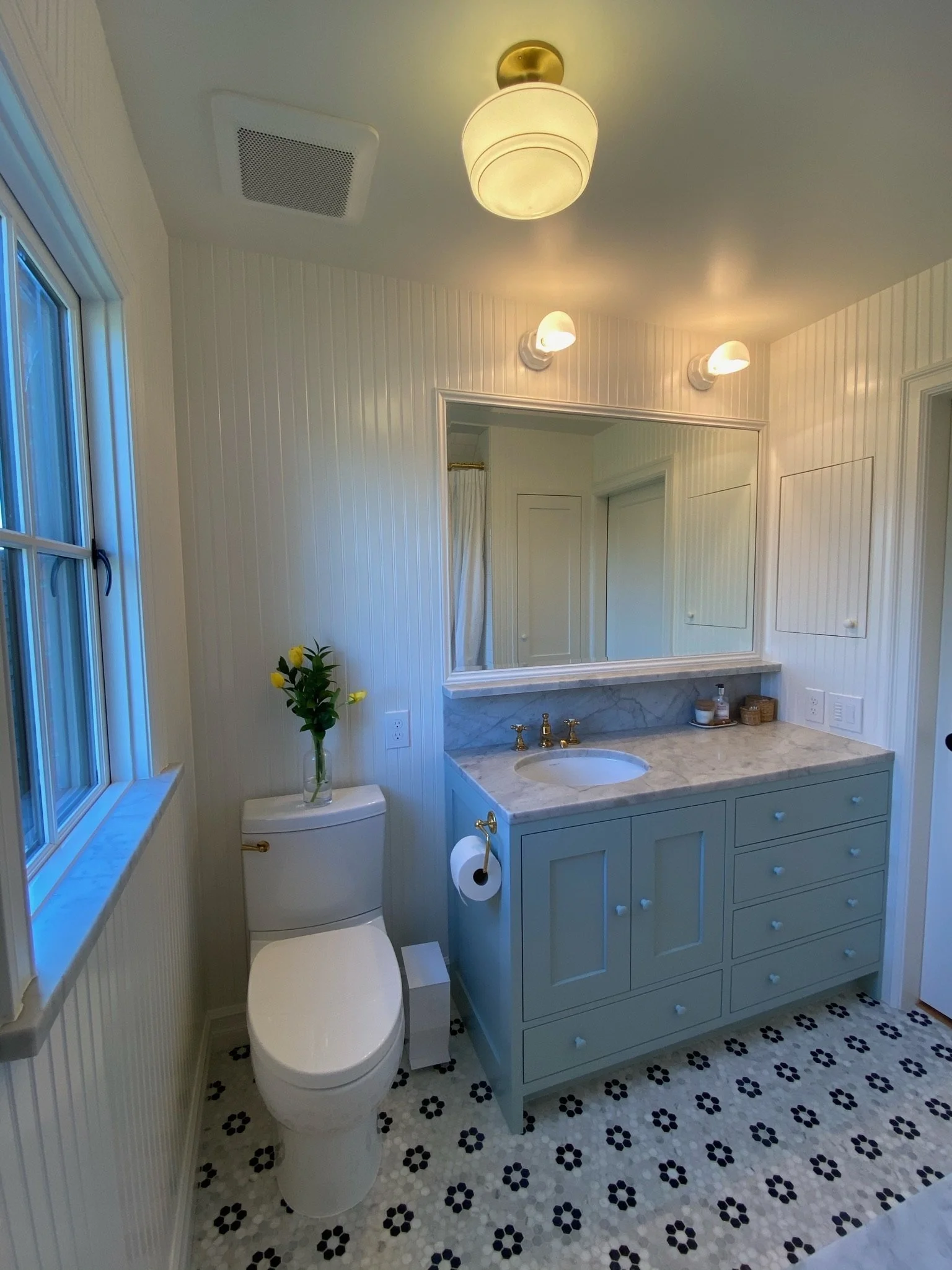 Bathroom with blue double vanity and patterned floor tile — Magnolia, Seattle full home remodel