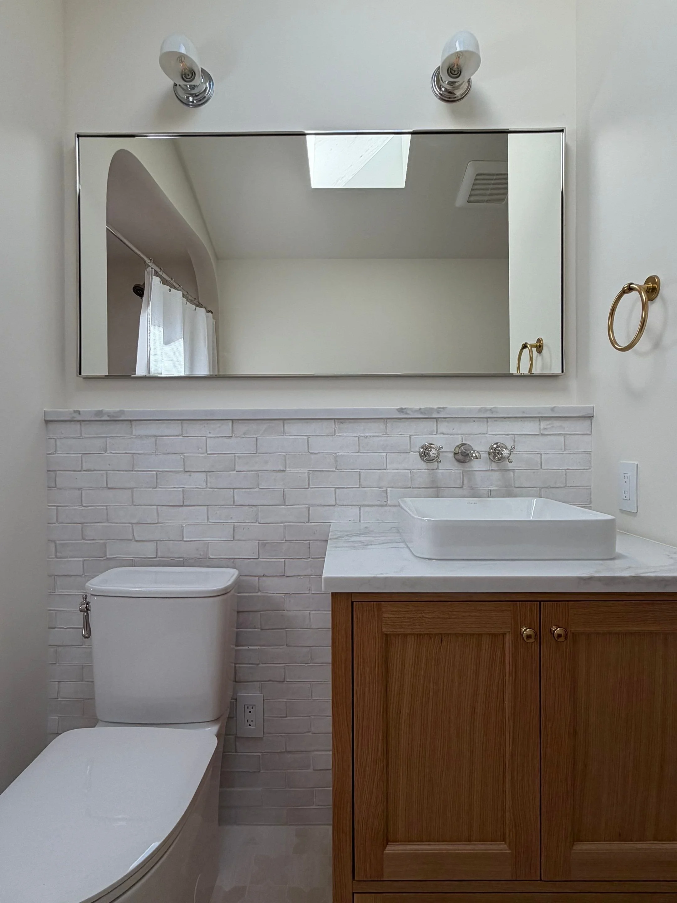 Bathroom with wood vanity and subway tile walls — Seattle remodel