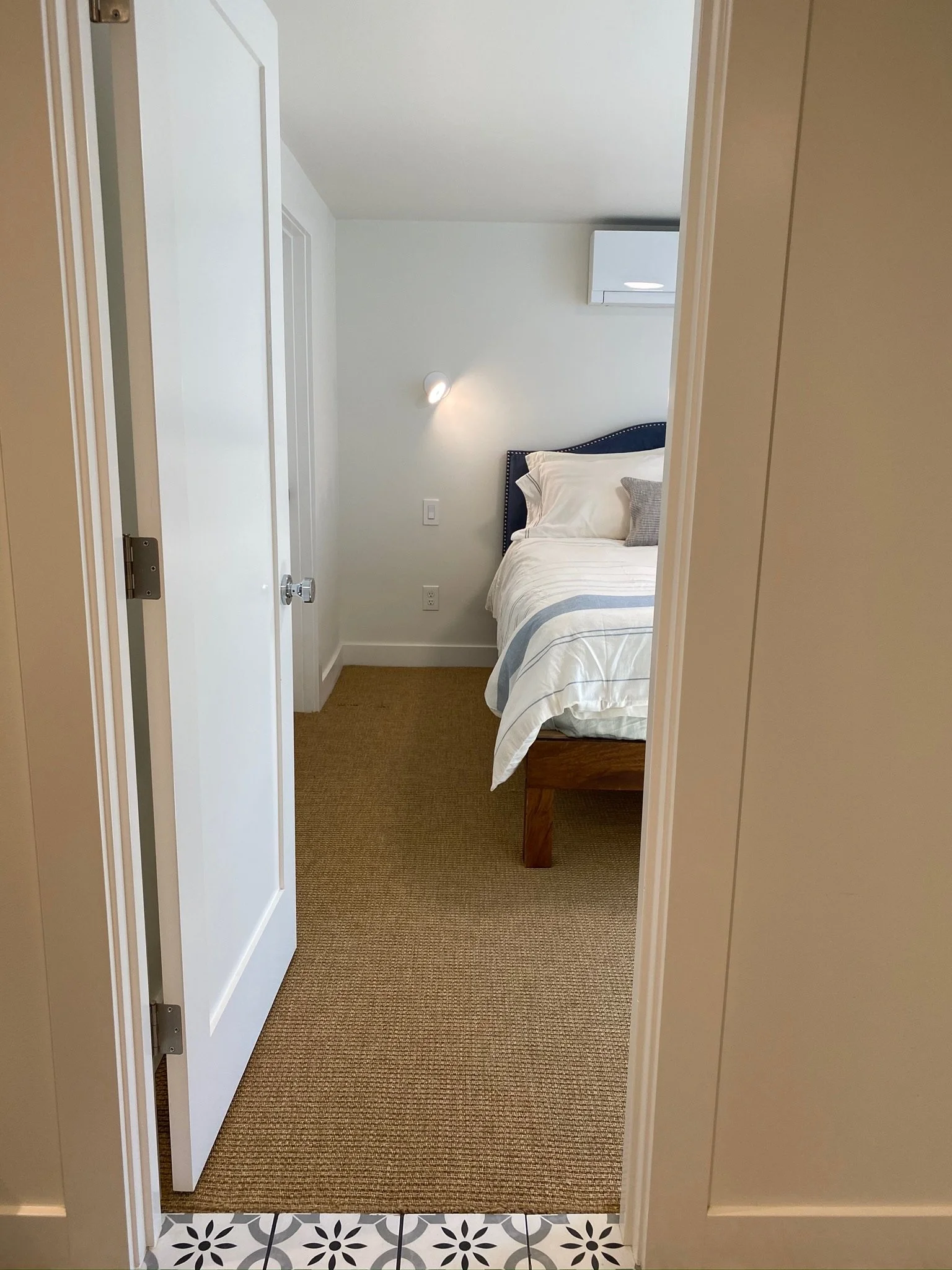 View through hallway with patterned tile flooring into a bedroom — Magnolia, Seattle full home remodel