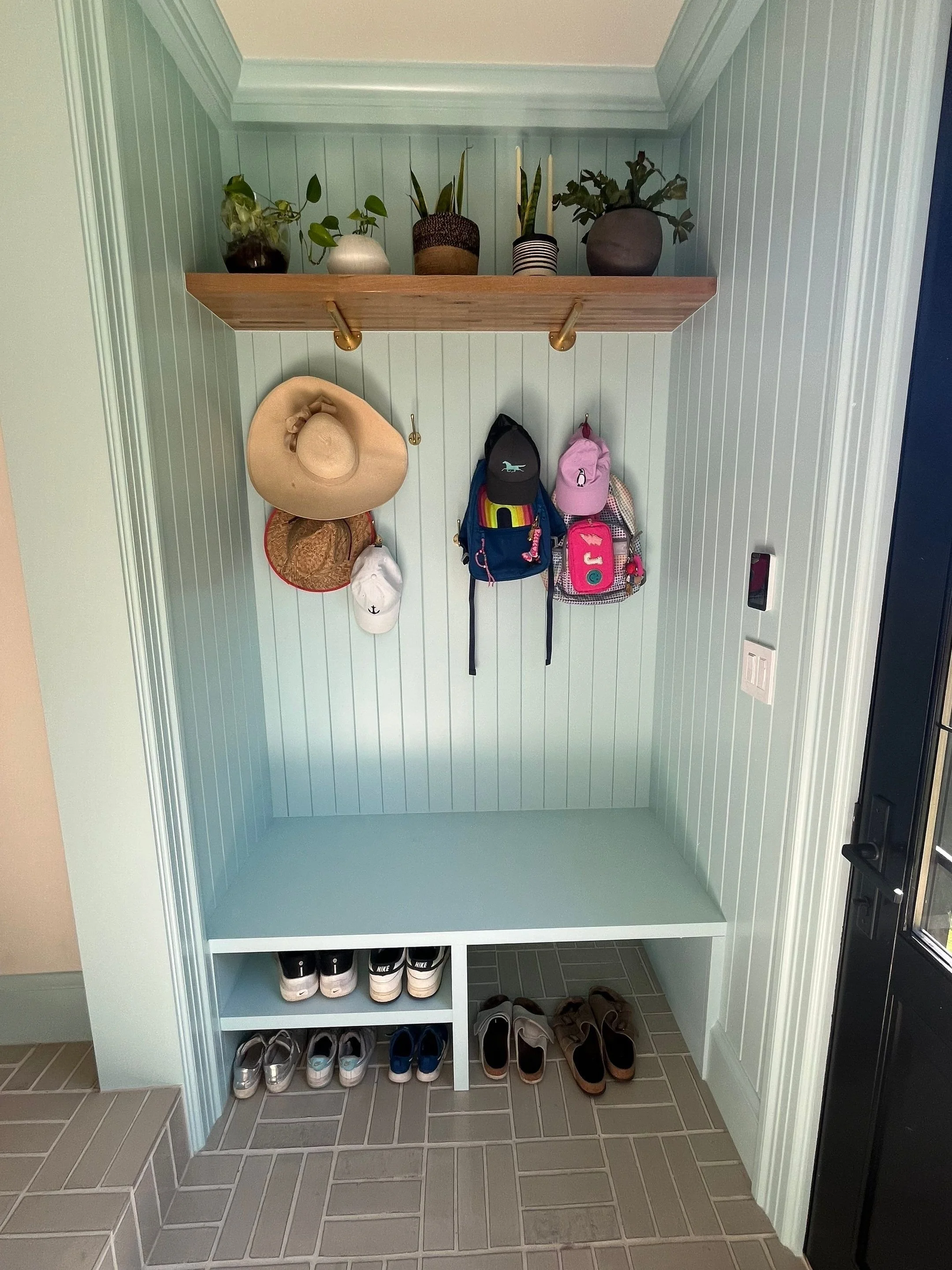 Built-in mudroom cubby with wood shelf, hooks, and shoe storage — Magnolia, Seattle full home remodel