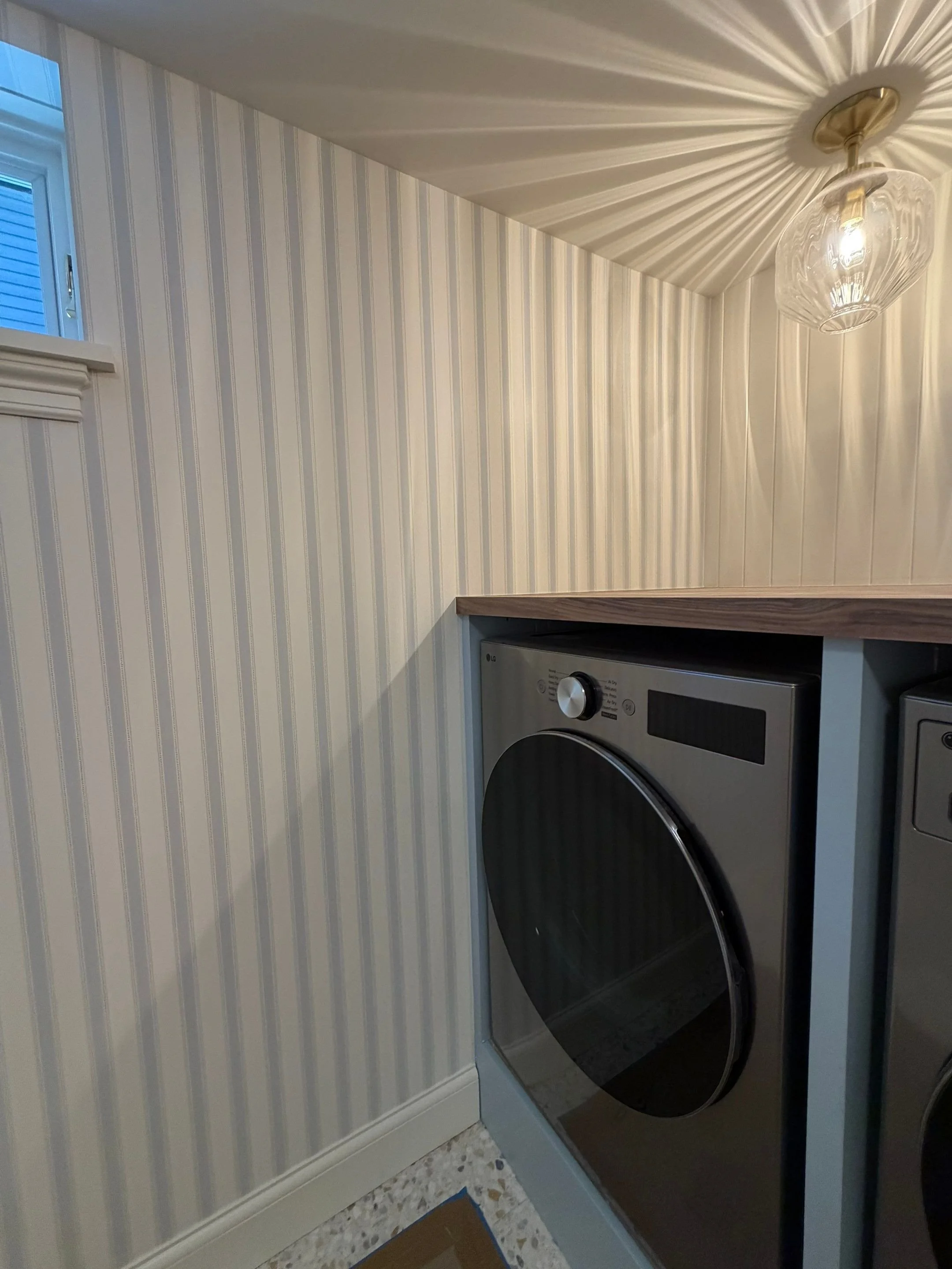 Laundry nook with striped wallpaper and flush-mount lighting — Discovery Park, Seattle whole-home addition