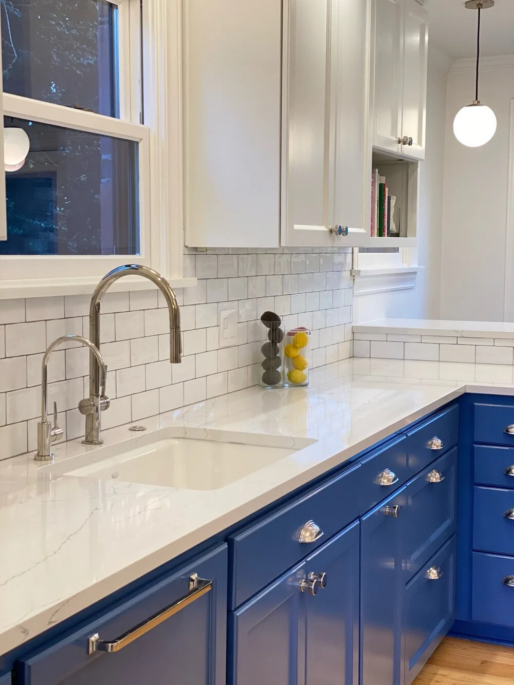 Kitchen with navy blue cabinetry, white marble countertops, and a farmhouse sink — Magnolia, Seattle full home remodel
