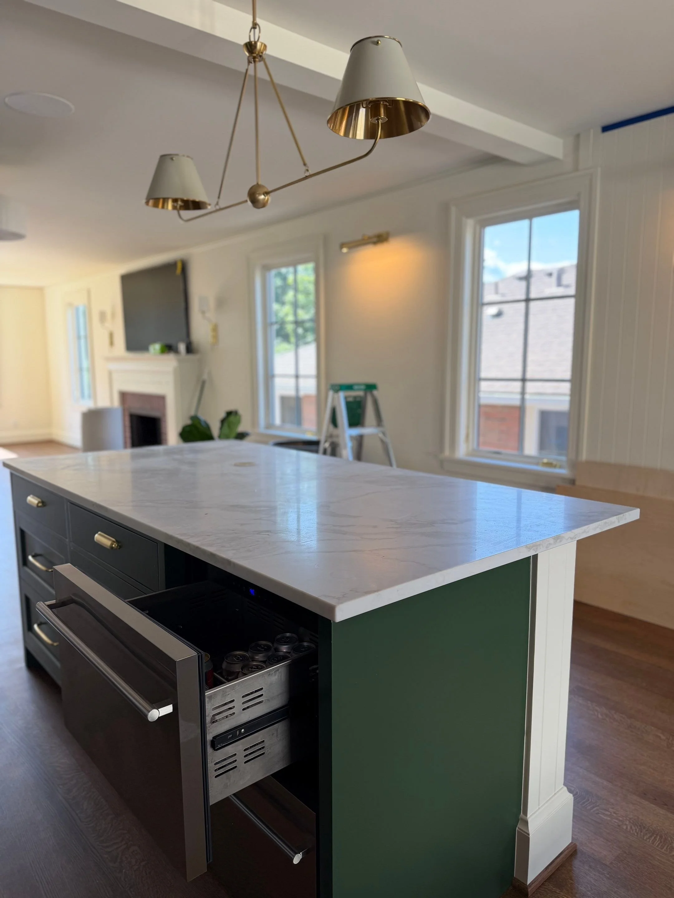 Kitchen island with waterfall quartz countertop and pendant lighting — Discovery Park, Seattle whole-home addition
