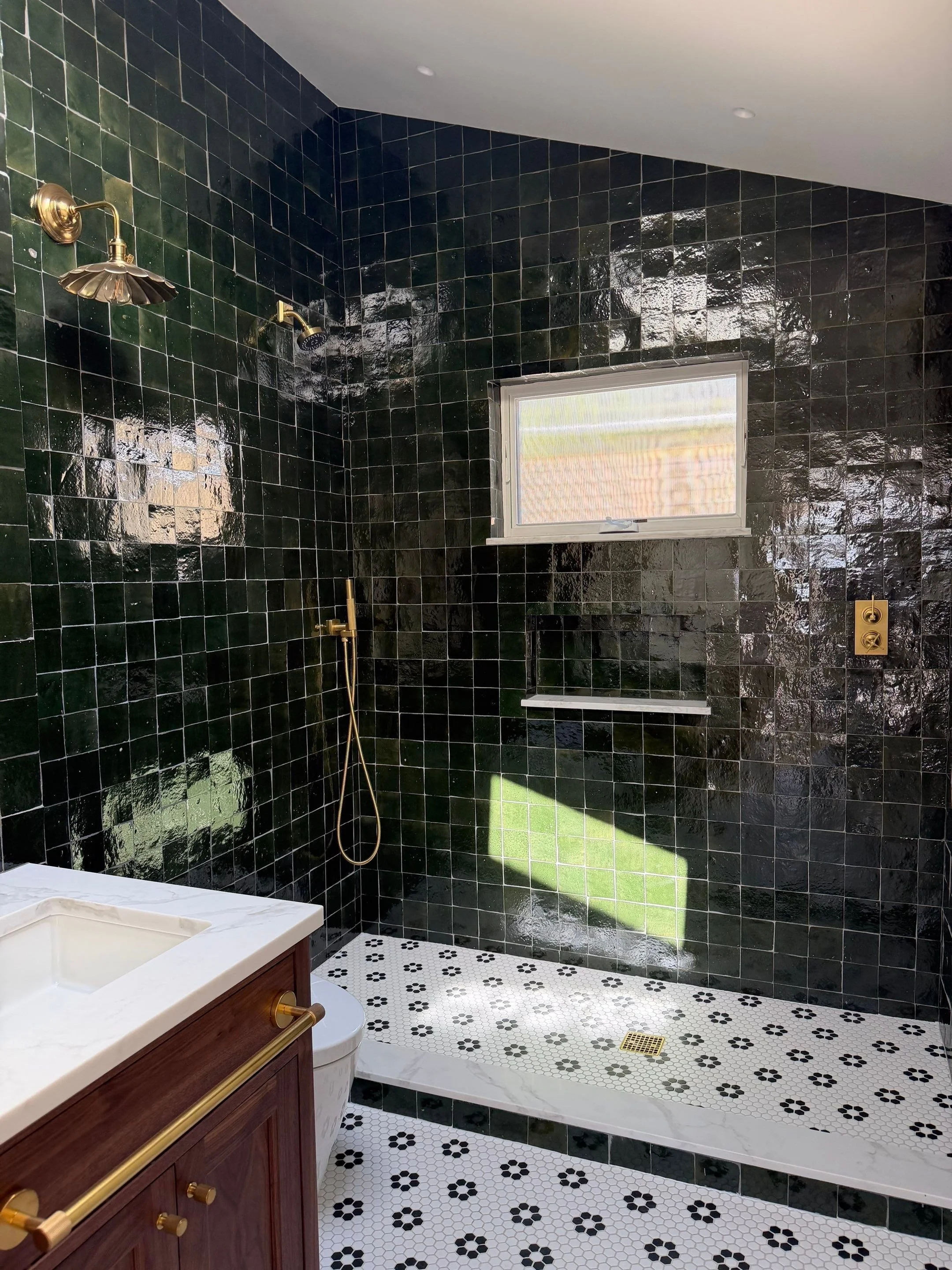 Bathroom vanity detail with dark green hexagonal tile and patterned floor — Discovery Park, Seattle whole-home addition