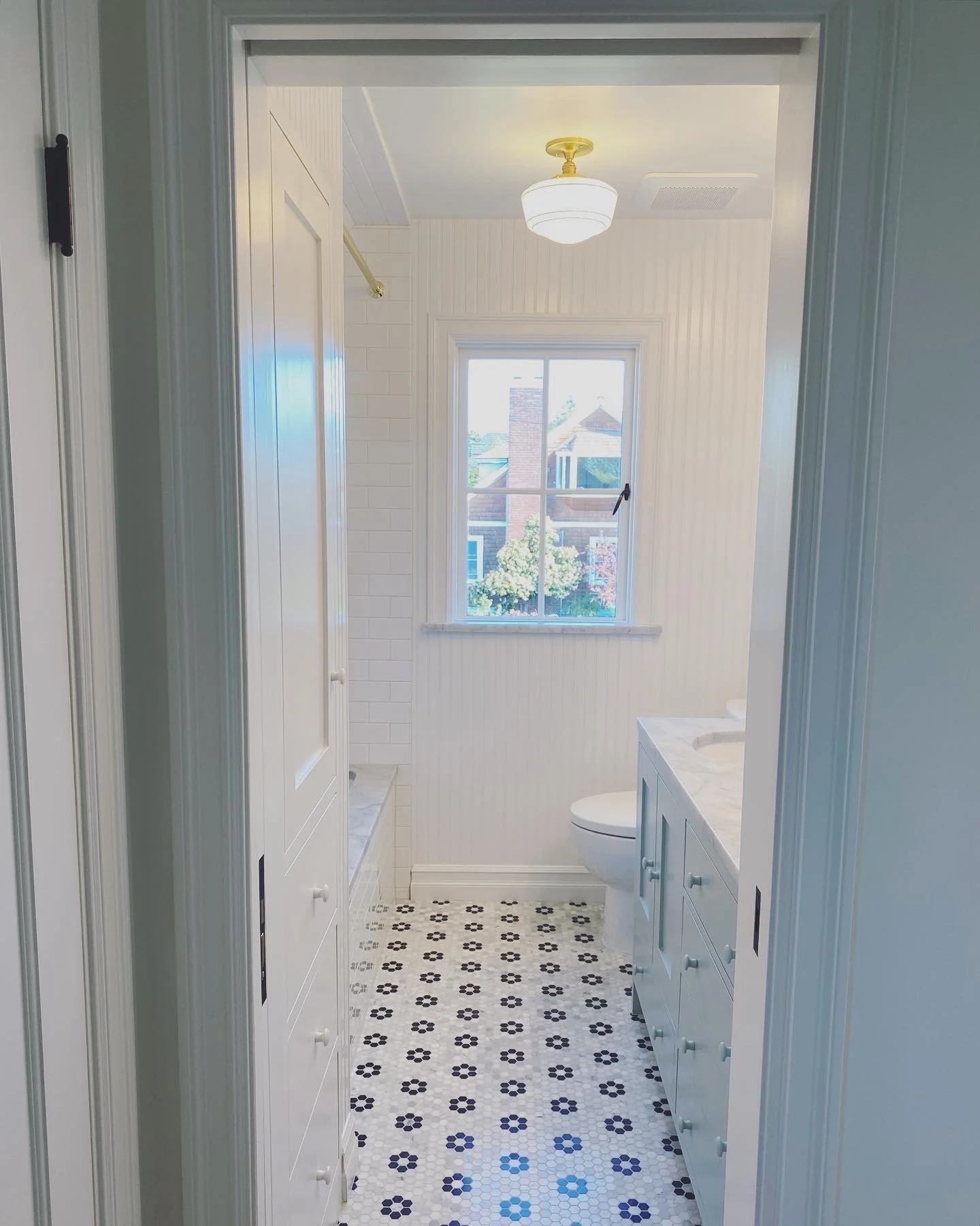Hallway with green penny tile flooring leading to the bathroom — Magnolia, Seattle full home remodel
