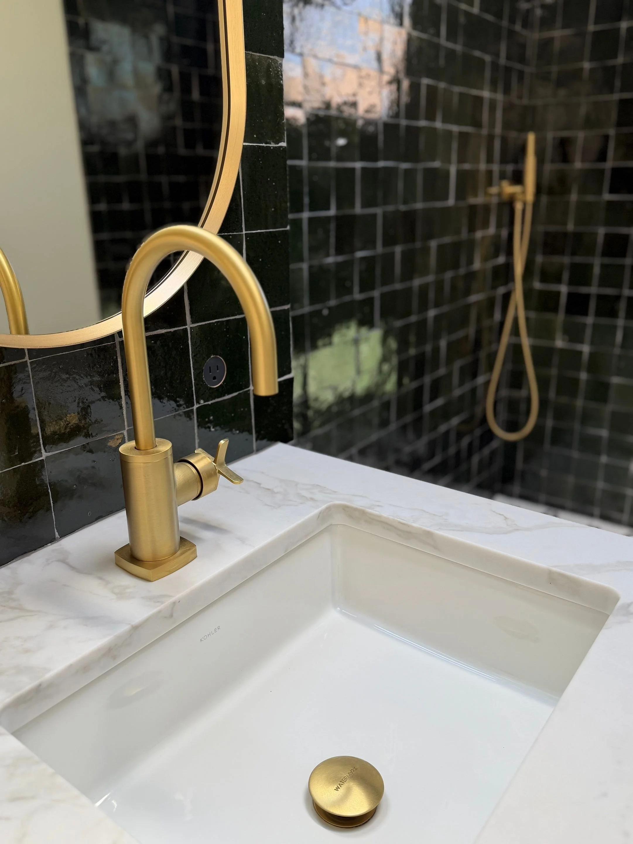 Close-up of a brass gooseneck faucet and marble sink — Discovery Park, Seattle whole-home addition