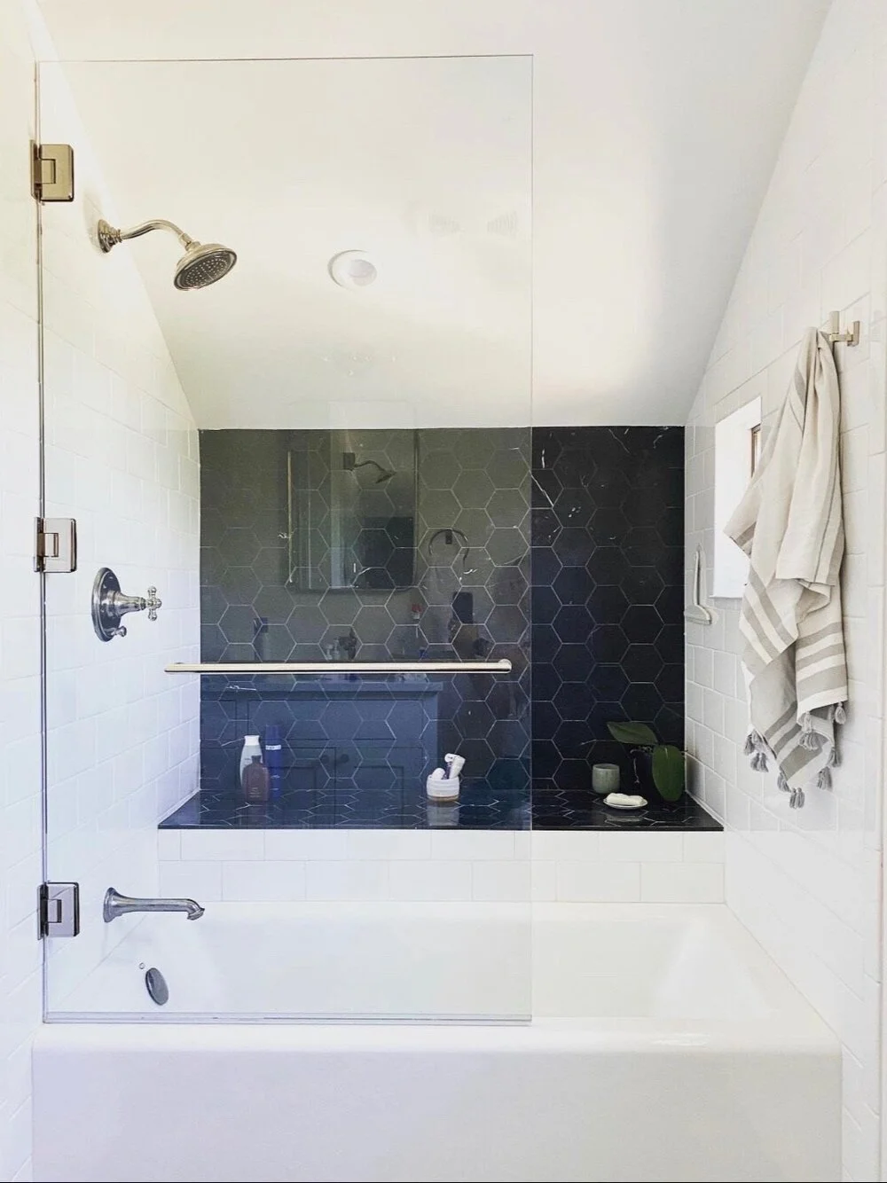 Glass-enclosed shower with navy tile and brass fixtures — Magnolia, Seattle full home remodel