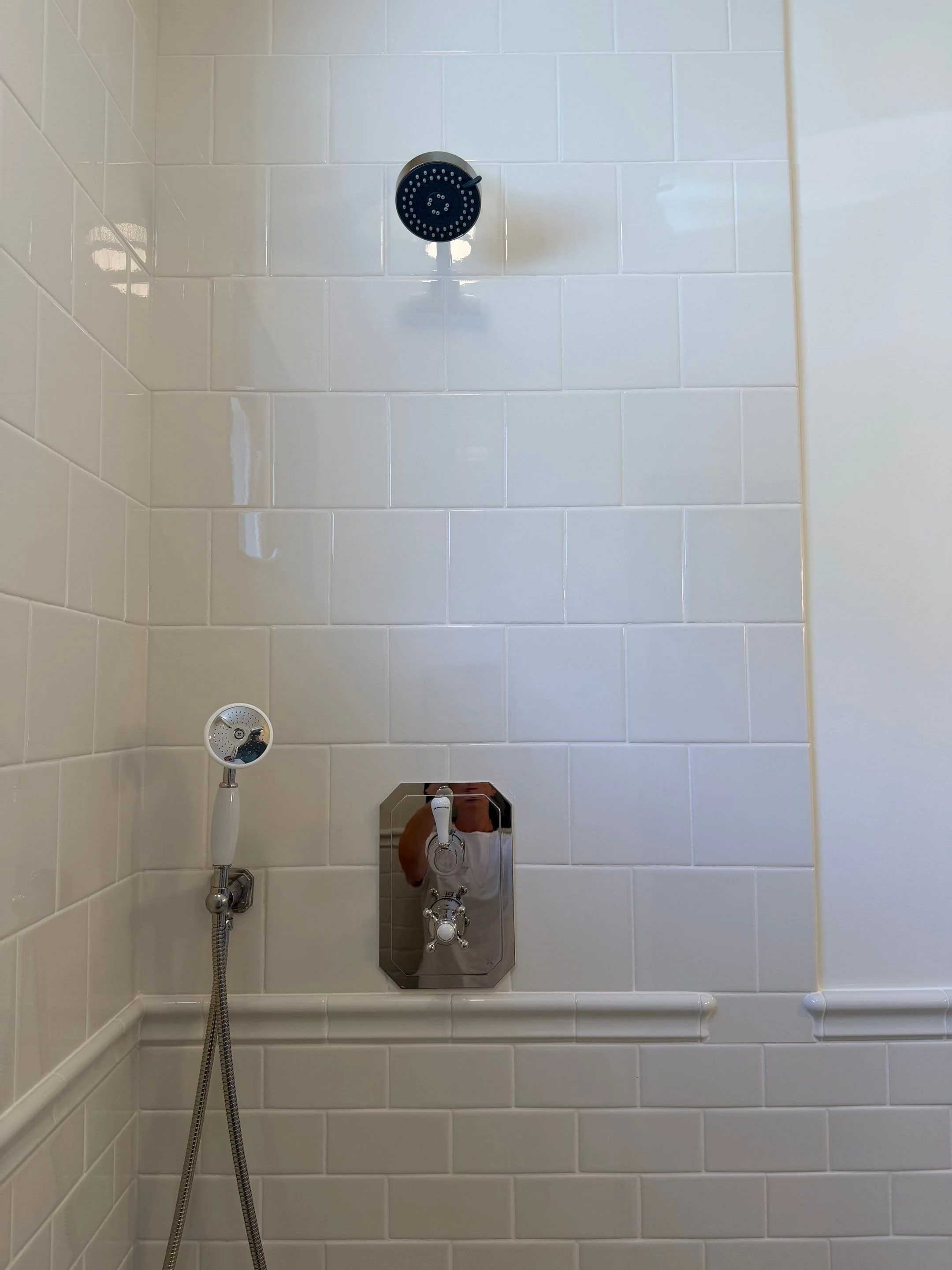Detail of white subway-tiled shower fixtures — Discovery Park, Seattle whole-home addition