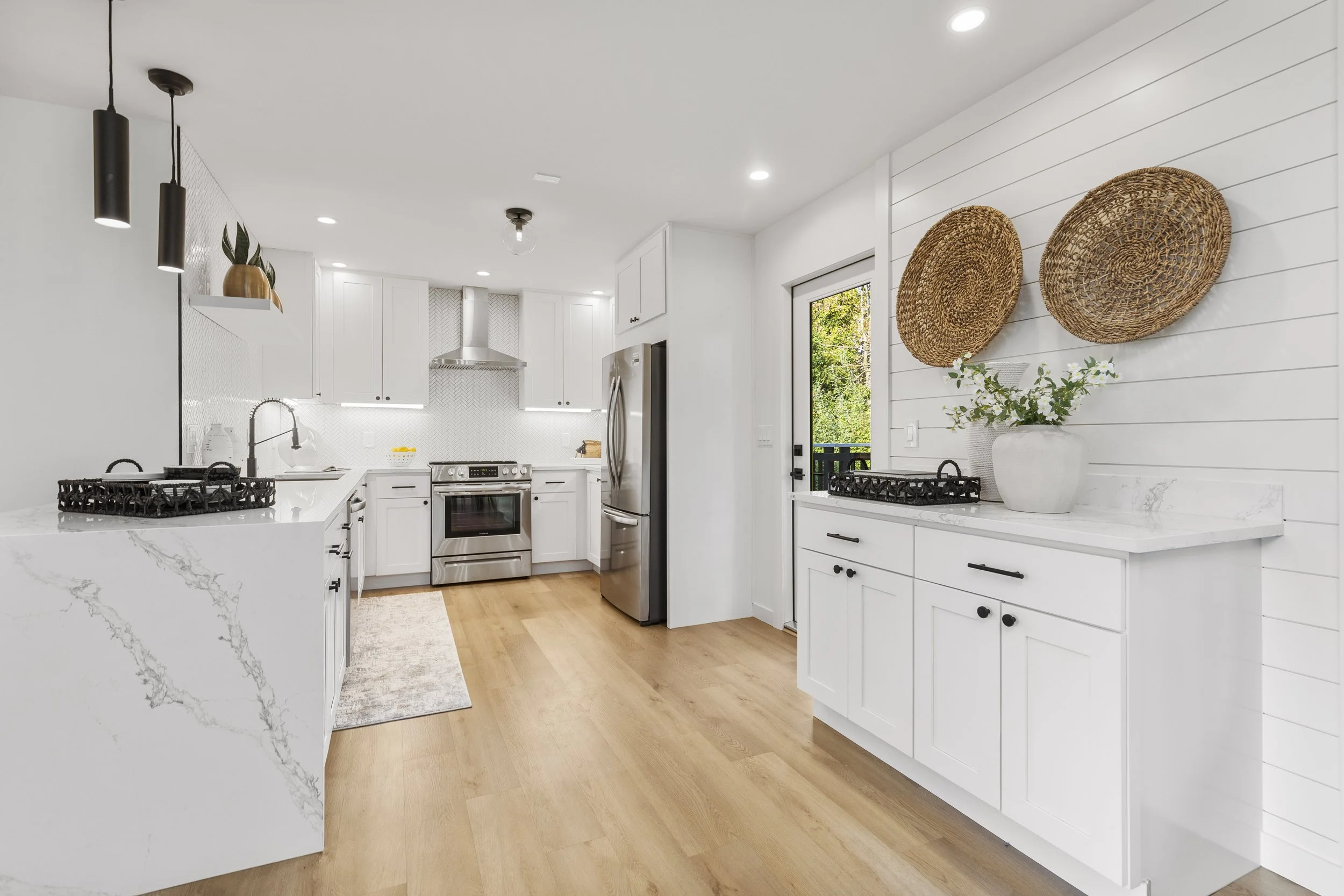 Bright kitchen with white cabinetry and shiplap wall — Seattle remodel