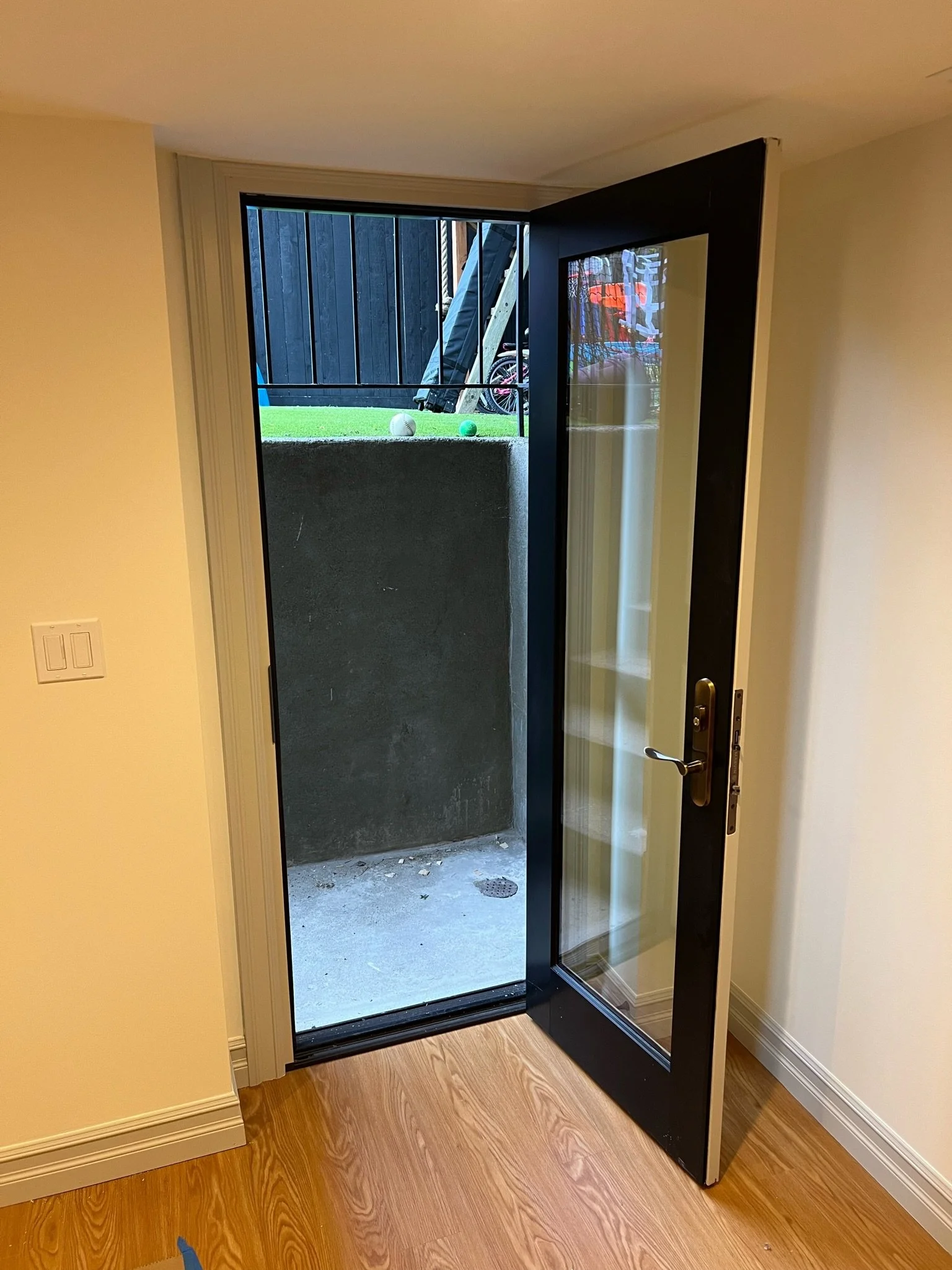 Black-framed glass door opening to the exterior patio — Magnolia, Seattle full home remodel