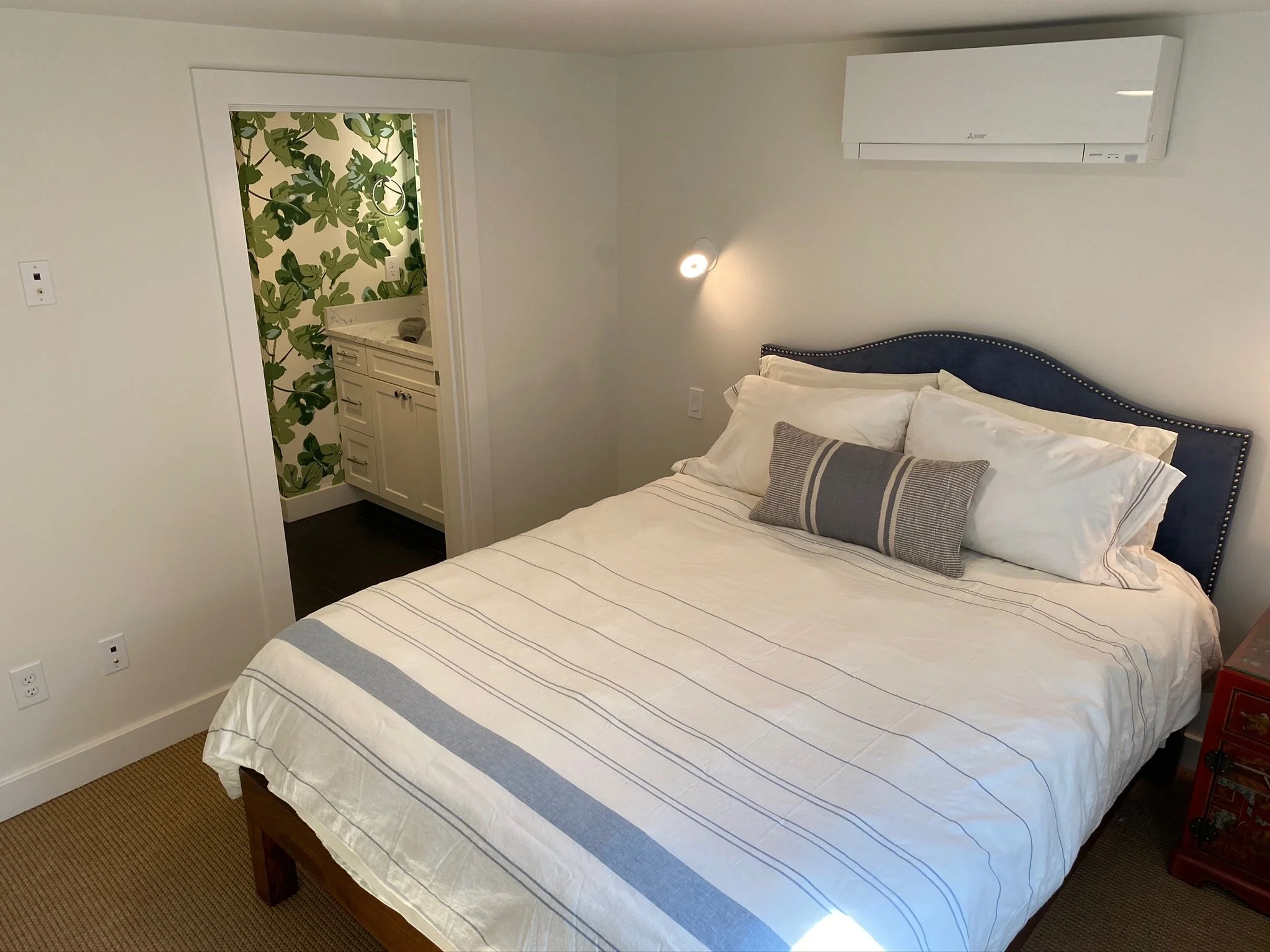Bedroom with botanical accent wallpaper and white bedding with navy stripe — Magnolia, Seattle full home remodel