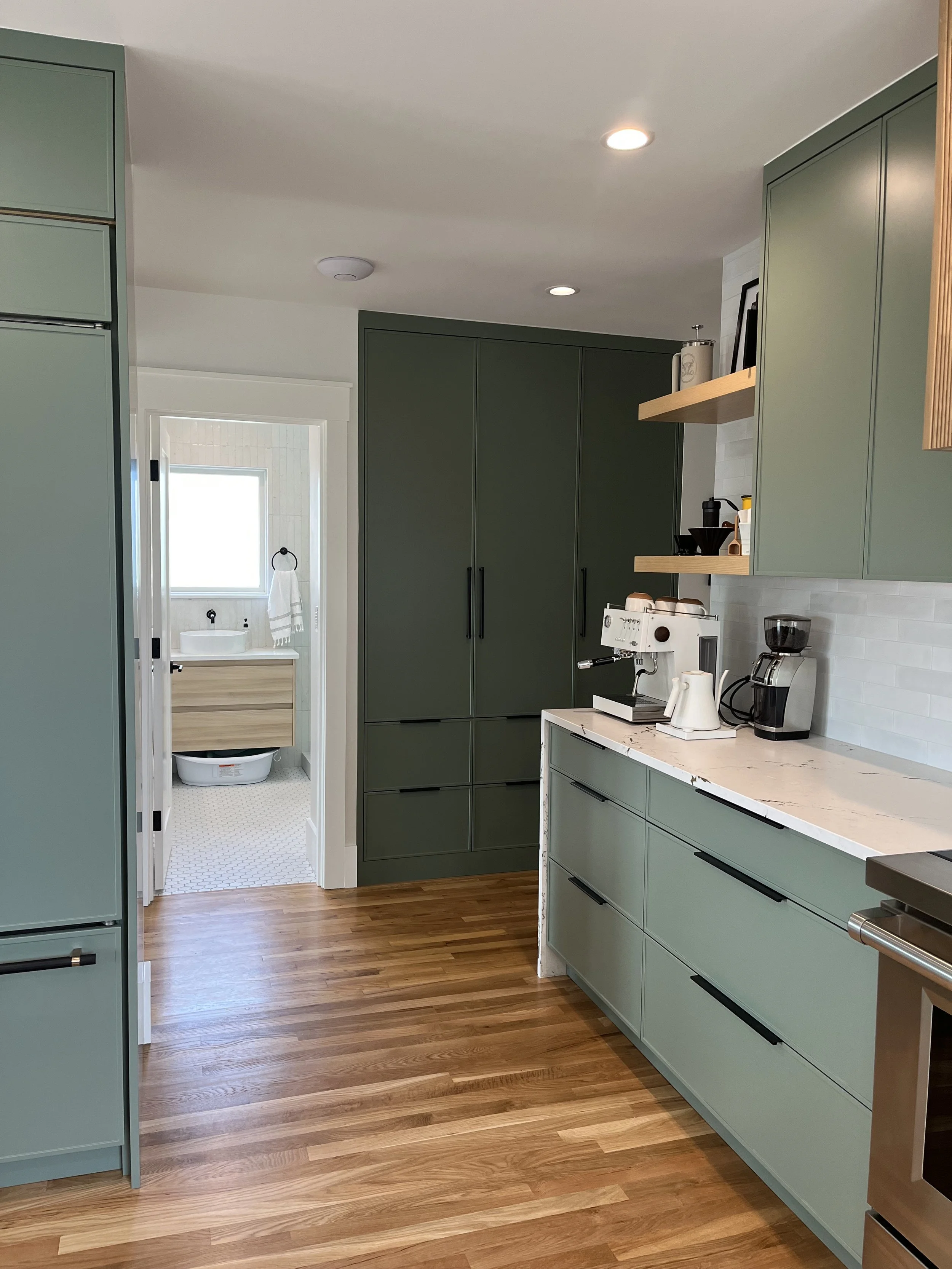 Kitchen cabinetry run with open wood shelving and hardwood flooring — Wallingford, Seattle kitchen and bath remodel