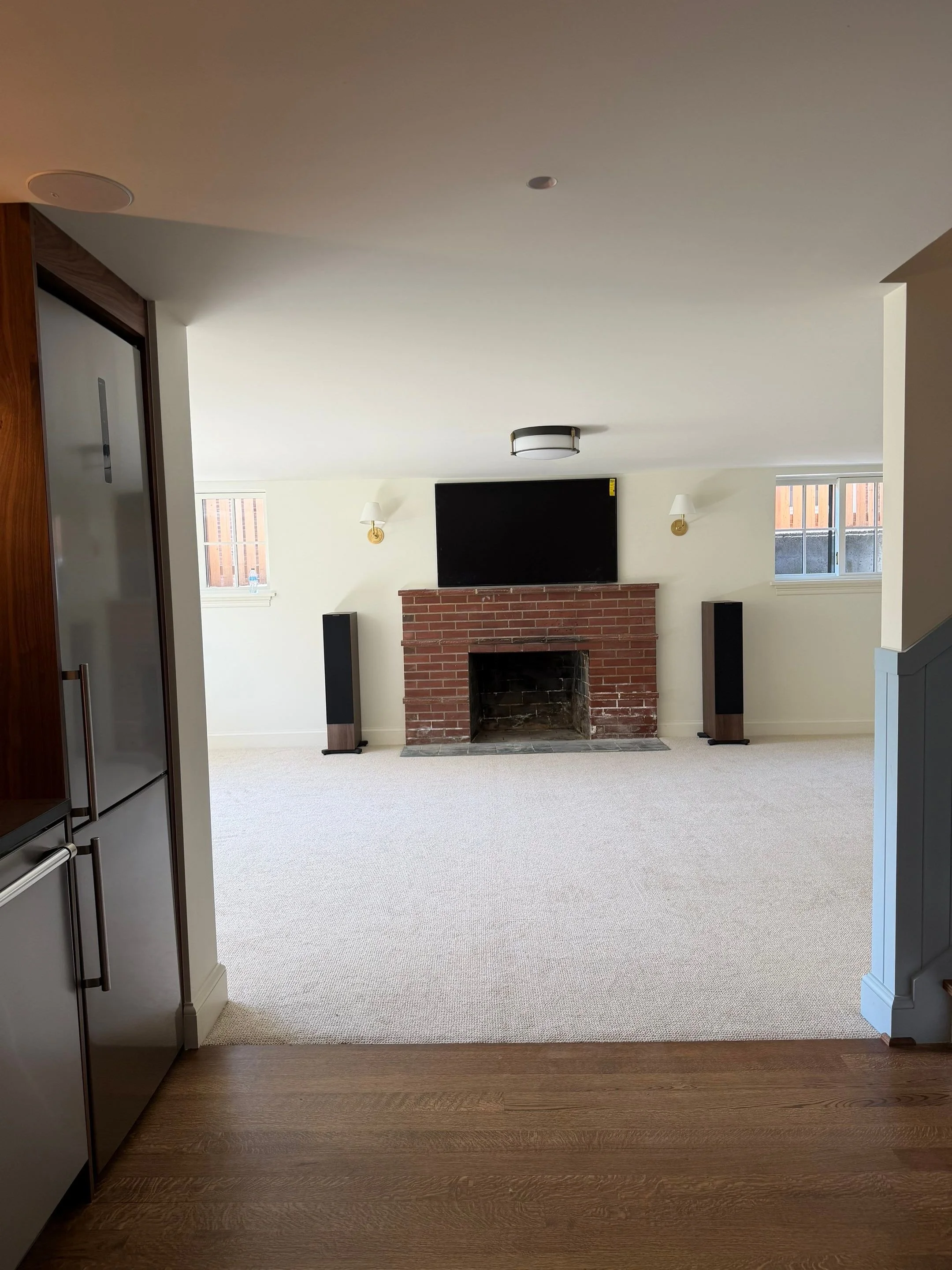 Living room with fireplace and mounted television — Discovery Park, Seattle whole-home addition