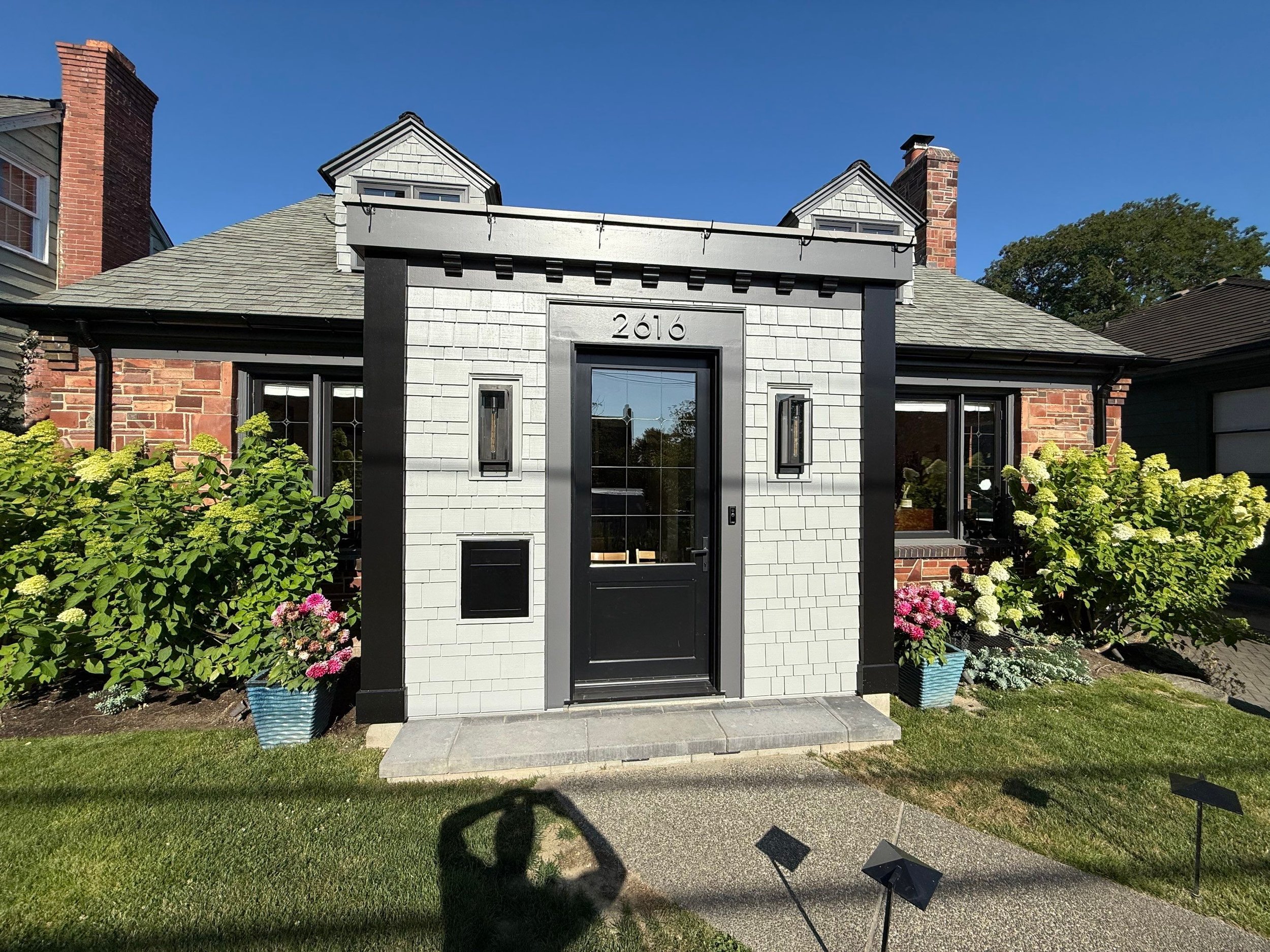White Cape Cod home exterior with black trim and shake siding — Magnolia, Seattle full home remodel